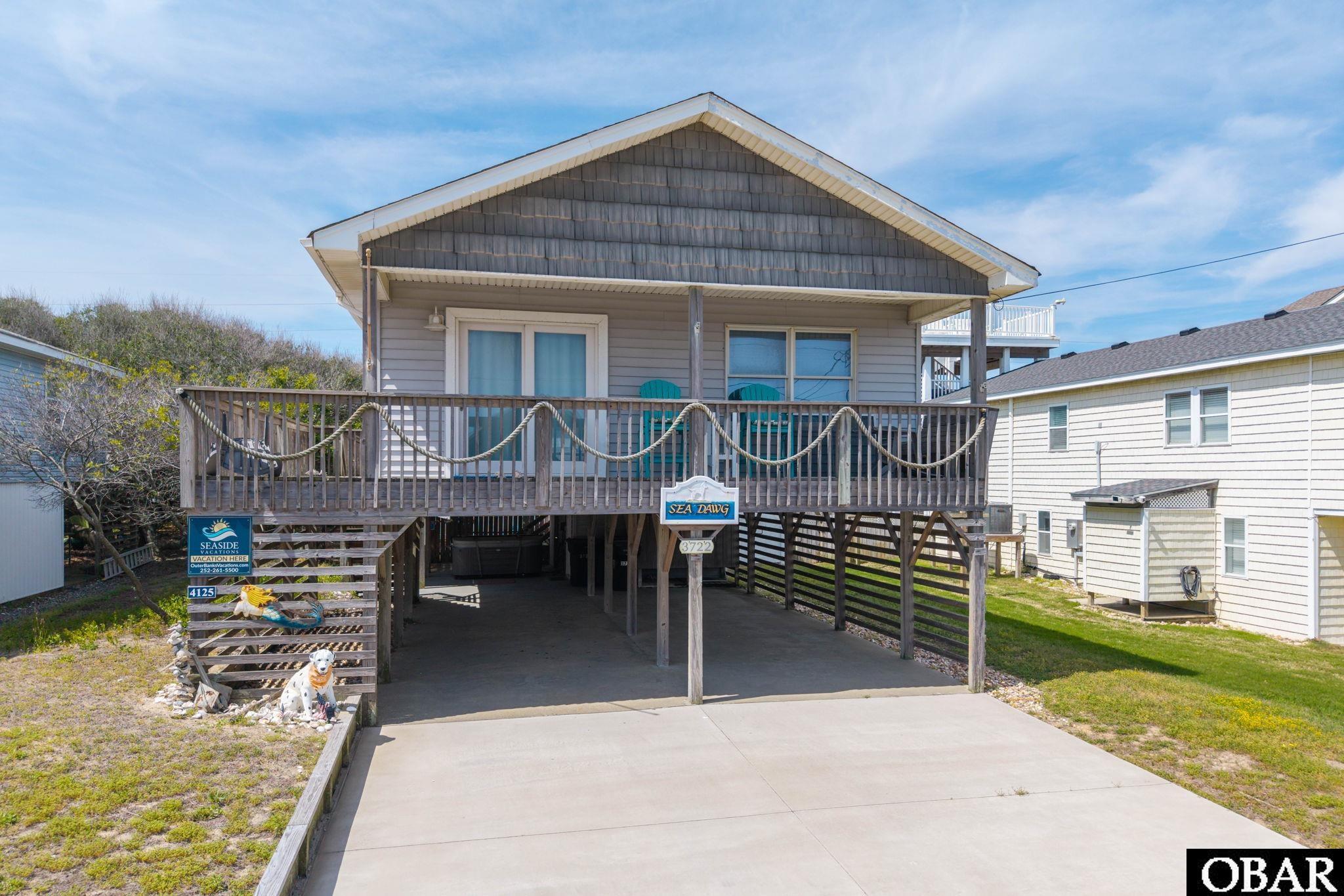 This charming, updated 3-bedroom, 2-bath home at Milepost 4.5 sits on a generous 10,000 sq ft lot on a quiet, private street—just an easy walk to the beach.Located on sought-after Hallet Street, this property offers an exceptional blend of comfort, style, and investment potential. The light-filled, open-concept living, dining, and kitchen area is designed for effortless coastal living, featuring durable luxury vinyl plank flooring, updated windows and doors, and a well-appointed kitchen with granite countertops, stainless appliances, and clean, modern finishes.Indoor and outdoor living connect seamlessly, with both sun and covered decks extending the living space—ideal for entertaining or relaxing with ocean breezes and a subtle ocean view. The layout is both functional and inviting, highlighted by a private King en suite with direct deck access, along with a Queen bedroom and a bunk room served by a beautifully renovated hall bath.The outdoor space is equally impressive, featuring a private pool, 8-person hot tub, outdoor shower, fenced backyard, and covered parking—creating a true resort-style setting with added privacy and convenience.Enjoy easy access to the White Avenue beach access, along with nearby restaurants, shopping, and local attractions. The oversized homesite, desirable oceanside location, and low flood risk further enhance the property’s long-term value.Recent updates—including HVAC (2020) and refrigerator (May 2024)—support strong rental performance and turnkey appeal.Polished, coastal, and income-producing—this is Outer Banks living at its finest.