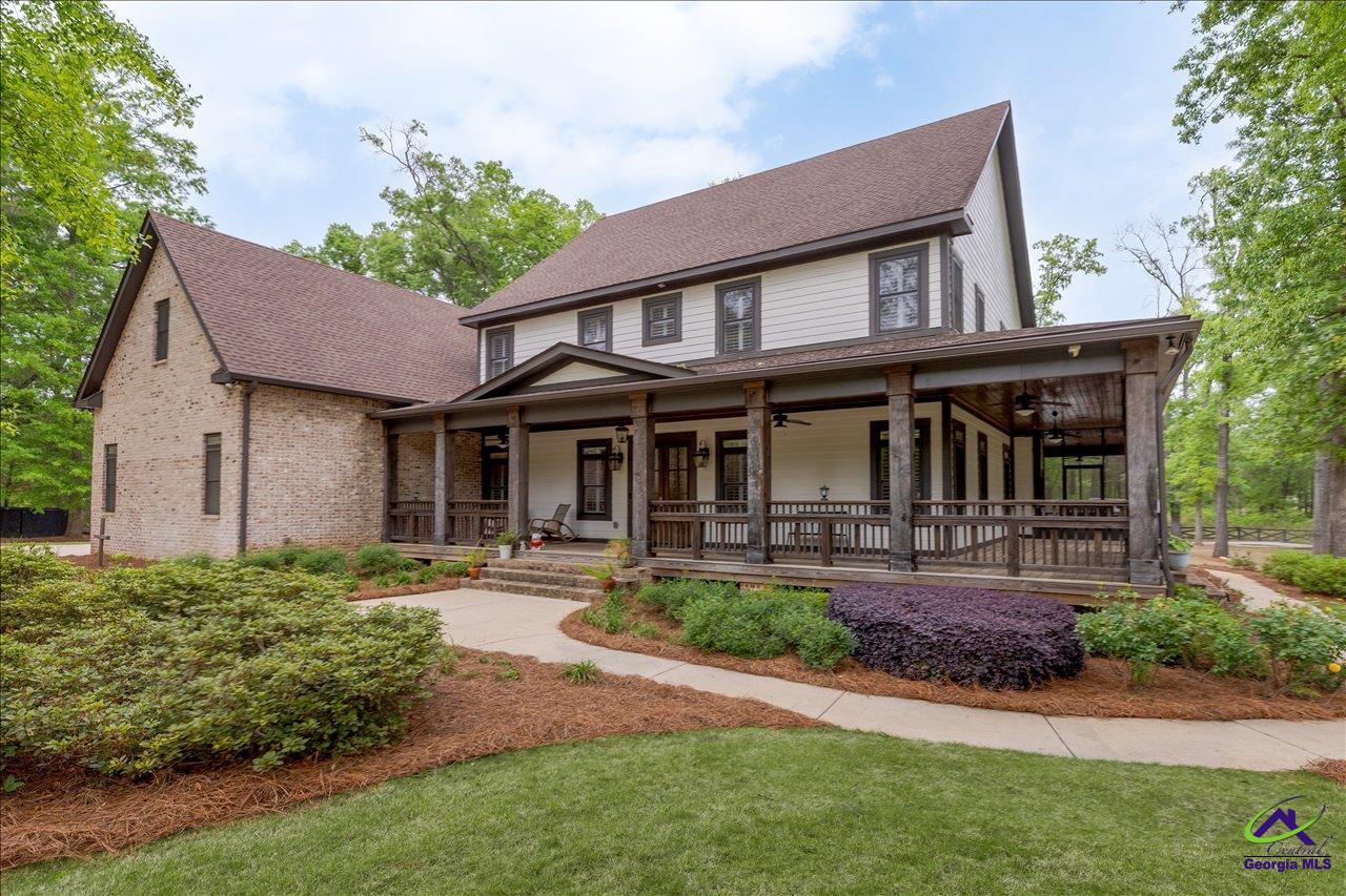 Welcome to Perrydise at 1031 Cherokee Road—your private retreat on 4.35 wooded acres. This stunning Craftsman-style custom home features a wraparound porch, an inviting screened porch in the back, and a heated gunite pool overlooking peaceful, private surroundings.  Inside, enjoy a chef’s kitchen with high-end appliances, gas cooktop, double ovens, two farmhouse sinks, butler’s pantry, and beautiful custom finishes throughout. The main level offers a luxurious primary suite with fireplace and spa-like bath, plus a guest bedroom.  Upstairs boasts a 1,200 sq ft bonus room with built-in sleeping area, wet bar, surround sound, and attic storage. Two bedrooms feature private baths, with two more sharing a Jack-and-Jill.  Additional perks include a garage flex space with half bath, irrigation on well, and camper hookup. A perfect blend of luxury, space, and privacy just minutes from town.