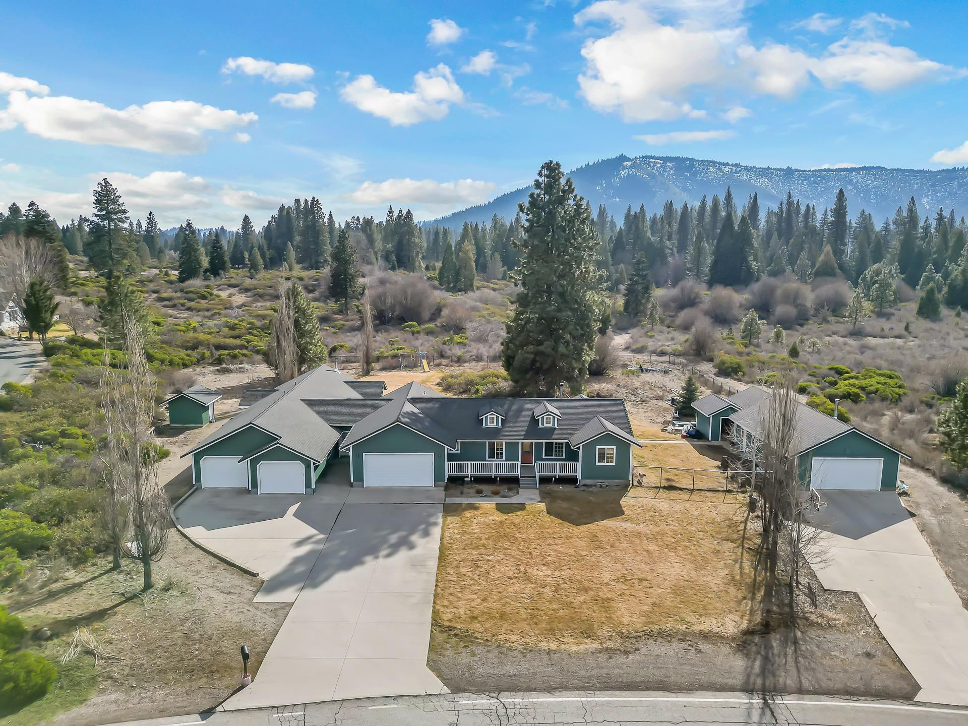 TWO HOMES!! A truly special opportunity in one of Mt. Shasta’s most sought-after neighborhoods, this beautifully situated and unique 2.5-acre property offers the perfect blend of space, flexibility, and peaceful mountain living. Ideal for multigenerational living or income potential, the property features a beautiful 3 bed, 2 bath main home, along with a separate 2 bed, 1.5-bath second residence, each thoughtfully designed for comfort, privacy, and functionality. The main home welcomes you with vaulted ceilings, custom cabinetry, quality finishes, and a bright, open layout filled with natural light. New decks and mature landscaping invite you to enjoy seamless indoor-outdoor living year-round, perfect for entertaining, relaxing, or simply soaking in the surrounding mountain scenery. An abundance of garage space, a large workshop, and additional finished areas offer endless possibilities for a home office, studio, storage, or creative pursuits. Tucked into a quiet, highly desirable neighborhood with a peaceful country feel, yet just minutes from town amenities and easy freeway access. This rare and versatile property offers both exceptional lifestyle appeal and long-term value.