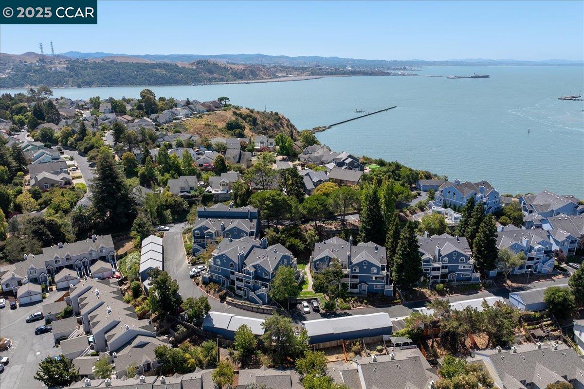 Tucked away near the Bay yet moments from major commute routes, this beautifully updated Sandy Beach condo offers the best of both convenience and coastal living. This home boasts 1,464 sq ft, 2 bedrooms, 2.5 baths, and a flexible bonus room that can easily serve as a third bedroom. The light-filled living room welcomes you with soaring ceilings, expansive windows, and a cozy fireplace, creating an inviting space to relax or entertain. The remodeled kitchen features a stylish blend of granite, marble, and tile finishes, modern appliances, and opens seamlessly to the dining area—perfect for everyday living and gatherings. Upstairs, two spacious ensuite bedrooms provide privacy and comfort, including one with a private balcony retreat ideal for morning coffee or evening unwinding. Recent upgrades include new carpet, fresh interior paint, updated fixtures, and the convenience of in-unit laundry. Additional perks include a one-car garage with extra storage, gated community entry, and a community pool—enhancing both security and lifestyle. Built in 1994, this well-maintained home blends modern updates with a smart, functional layout. Located near Cal Maritime, ferry access, parks, trails, and Vallejo’s vibrant waterfront.  Beautiful Bay Area living without the Bay Area price tag!