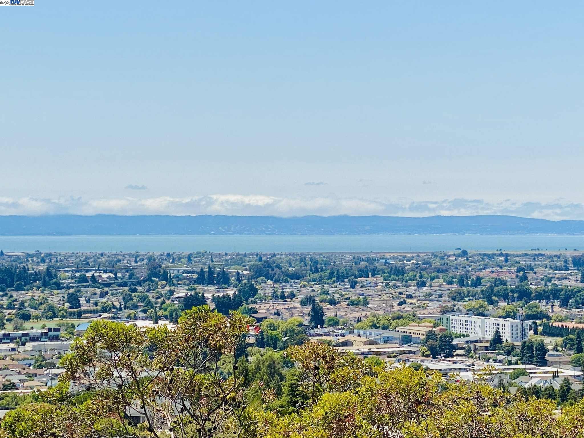 AMAZING VIEWS with a light-filled TWO BEDROOM, TWO FULL BATH condo that puts sky-high CITY VIEWS front and center! This dazzling home offers sunny spaces and a sweeping, OVERSIZED BALCONY perfect for morning coffee or sunset gatherings to watch over the sparkling BAY VIEWS. Enjoy the freedom of single-level living—NO STAIRS TO ENTRY, just easy access for all your daily adventures. The open kitchen features stainless steel appliances and a welcoming breakfast bar ideal for friends and family. Cozy up next to the inviting fireplace in a spacious living room designed for relaxation and entertaining. Easy to maintain wood laminate floors and convenient IN UNIT LAUNDRY—washer and dryer included! LOTS OF CLOSET SPACE and DUAL PANE WINDOWS. Move in and start living w/one covered assigned parking spot, a private fitness center, and water and trash services covered. The COVETED CASTRO VALLEY SCHOOL DISTRICT is your gateway to top-rated education, and world-class commuting puts Oakland, San Francisco, and the BART just minutes away. With interest rates down, the chance to own this radiant retreat won’t last—make your move and elevate your everyday!