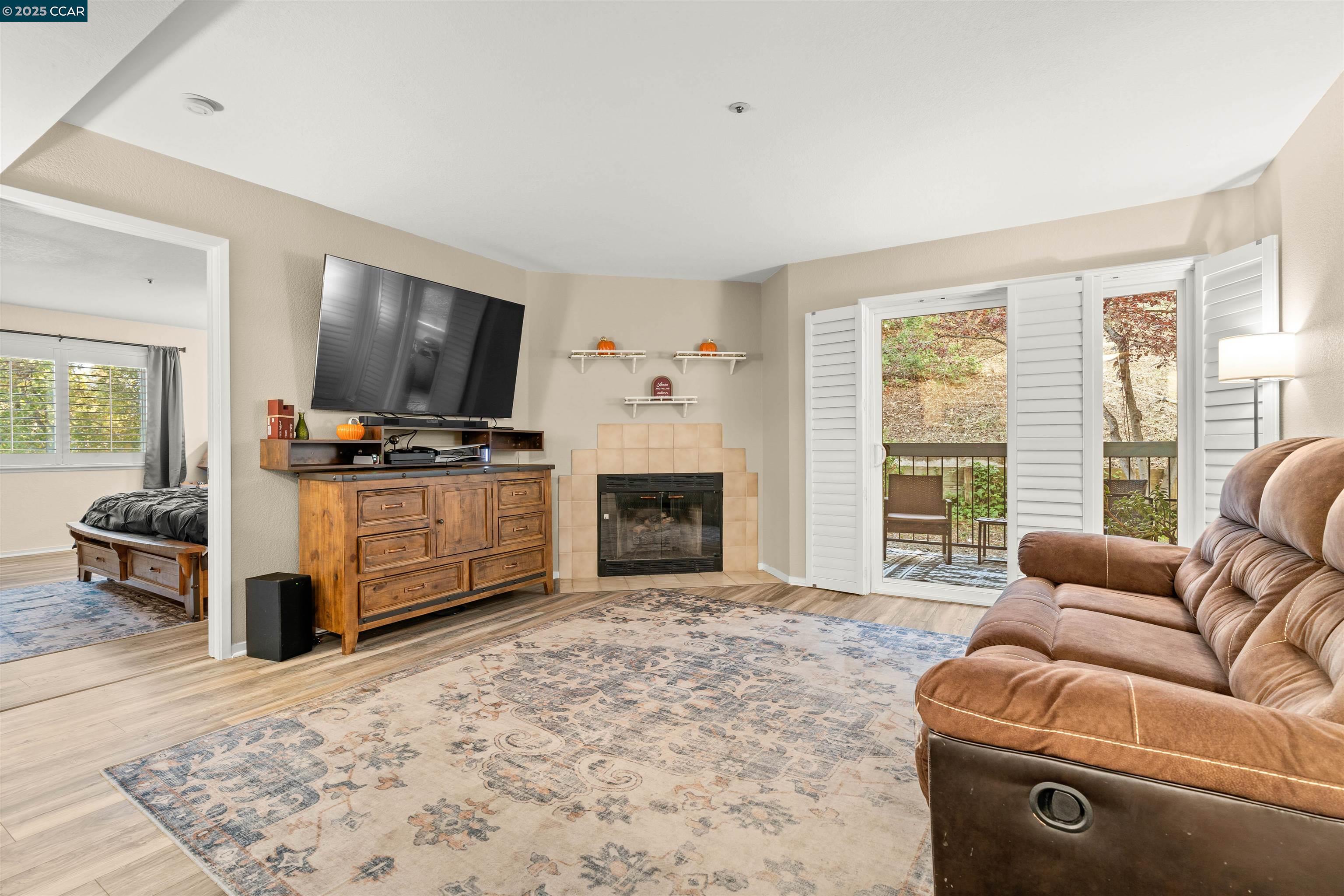 Do not miss this opportunity, situated in a great location in the complex. This 2 bedroom, 2 full bathrooms is the largest model with 1,122 sq. ft. Stunning and beautifully updated, starting with the kitchen's lovely Granite Counters, Stainless Steel appliances, next to your stack washer and dryer, ending with an oversized pantry. A Spacious Primary Bedroom, huge walk-in closet and a Large Primary Bathroom with a granite walk-in shower, dual wash basins and granite countertop.  The Large Living Room with a tiled fireplace and access to the patio by way of a sliding glass door.  Laminate flooring throughout the unit. Both bedrooms are separated by the Living room for each one's privacy. This unit is in a quiet location, with only two neighbors, and an extra window in the Primary Bedroom.  Note that there are shutters throughout this unit. The best for last, this unit includes TWO dedicated parking spaces under the building with secure gate access.  Building has an elevator access inside the building for safety. Community pool, Club house, Close to Newhall Park and shopping. Make this your home today!