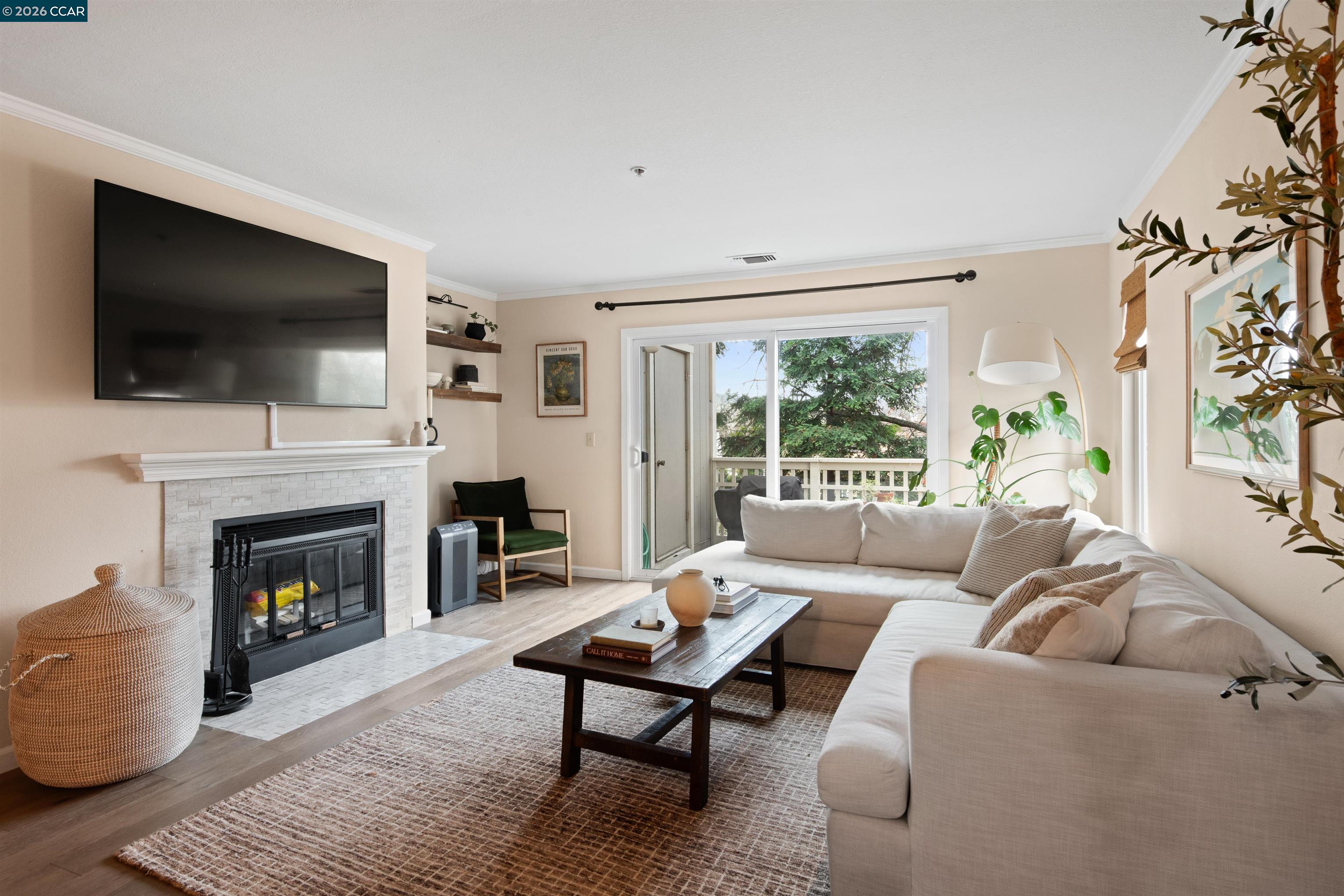 End-unit Walnut Creek condo offering comfort, convenience, and an unbeatable location. The open living and dining area provides a welcoming space for everyday living and entertaining, while large windows bring in abundant natural light. The updated kitchen offers ample cabinetry and counter space. The living area is highlighted by a tiled gas fireplace, built-in bar, and a private balcony.   Hardwood flooring throughout adds a polished, designer feel, while the end-unit location provides added privacy and a quiet atmosphere. Upstairs, you’ll find two spacious bedrooms and two full bathrooms, along with a washer and dryer for convenience. The primary suite includes custom closet shelving and a beautifully tiled double shower. Additional storage is abundant, including a large closet tucked beneath the stairs. Ideally located near BART, freeway access, shopping, dining, and everyday conveniences.