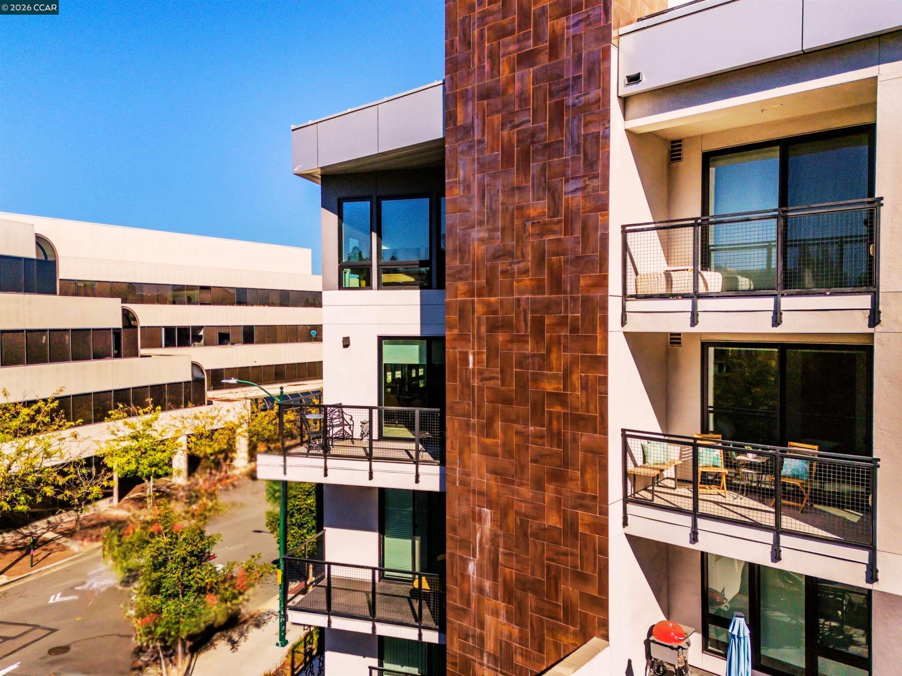 Nestled in the heart of downtown Walnut Creek, this bright and modern 1,074 sq ft, 2-bedroom, 2-bath home at The Riv offers the perfect blend of style, comfort, and convenience. With contemporary finishes and a thoughtful open layout, it’s designed for easy living in one of Walnut Creek’s most desirable locations.  Step inside to soaring floor-to-ceiling windows, hardwood flooring, and abundant natural light that fills every corner. The European-inspired kitchen features sleek cabinetry, quartz countertops, a spacious island, and stainless-steel appliances—seamlessly connecting to the open living area and south-facing balcony with peaceful, tree-lined views.  The primary suite offers balcony access, generous closet space, and a beautifully updated bath, while a convenient office nook sits just outside the secondary bedroom—ideal for remote work or study. Additional highlights include two deeded garage spaces, an extra storage unit, an in-unit laundry closet, and access to exceptional community amenities such as a rooftop deck with BBQ, garden patio with firepit, and a modern work lounge.  With shopping, dining, BART, and freeway access just steps away, this home combines luxury, location, and lifestyle—modern downtown living at its finest.