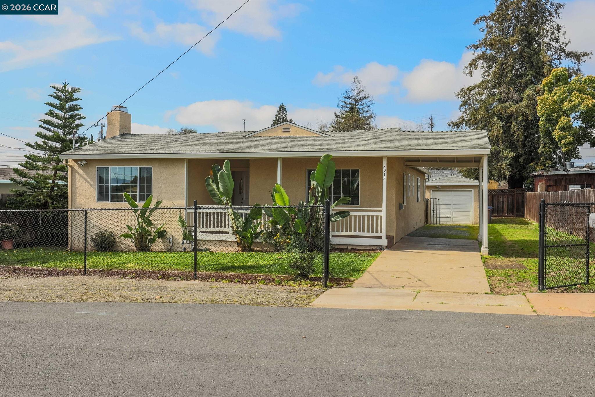 Charming and thoughtfully updated, this 3-bedroom, 2-bath home blends timeless character with everyday comfort. Built in 1947, the 1,287 sq ft layout is filled with natural light and hardwood floors throughout, creating a warm, welcoming atmosphere from the moment you step inside.  The kitchen features granite countertops and stainless steel appliances, perfect for both quiet mornings and easy entertaining. Enjoy cozy evenings gathered around the wood-burning stove, and year-round comfort with central HVAC.  Outside, a spacious yard offers room to garden, relax, or host friends, while the detached garage adds convenience and flexibility. With inviting curb appeal and a thoughtful mix of original charm and modern updates, this home is a place where memories are made and life is meant to be enjoyed. Open house Sat & Sun 1-4p.