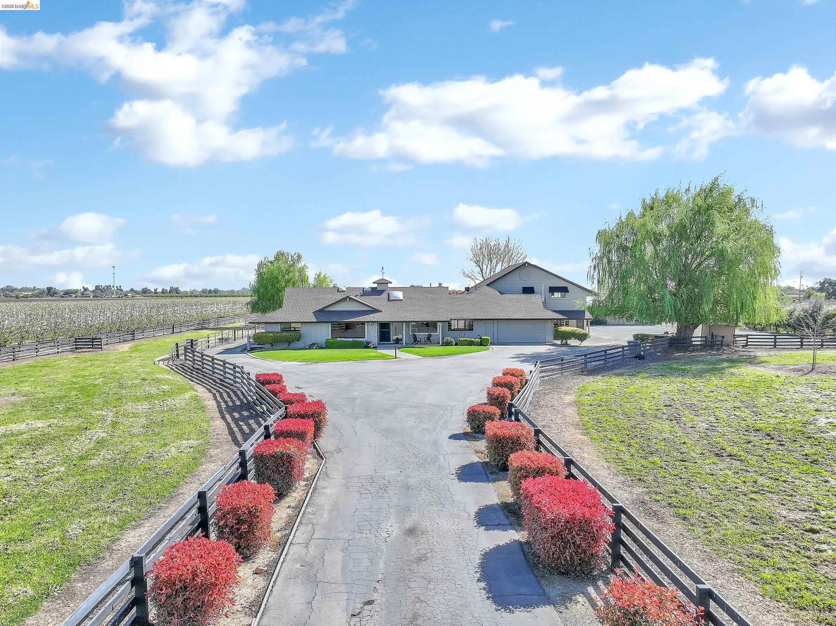 This expansive 5/acre estate features a 4,623 sf home with gorgeous views of Mt. Diablo, ideally located close to downtown dining and shopping. The residence includes a meticulously updated kitchen, family room, dining room, bedrooms, and baths. Additionally, the home offers a game room with a wet bar and a full entertainment area featuring a full oak bar. For flexible living arrangements, there is an upstairs in-law apartment with its own kitchen, full bath, and sitting area, as well as a side room with an outside entrance that can serve as a bedroom or office.  The exterior of the property is equally impressive, featuring: - A pool and spa - A tennis court - A horse barn, paddocks, and a riding area - A 5-acre cherry orchard and numerous fruit trees (citrus, apricots, peach, pear, apple, and pomegranates) - 70 owned solar panels powering the entire property