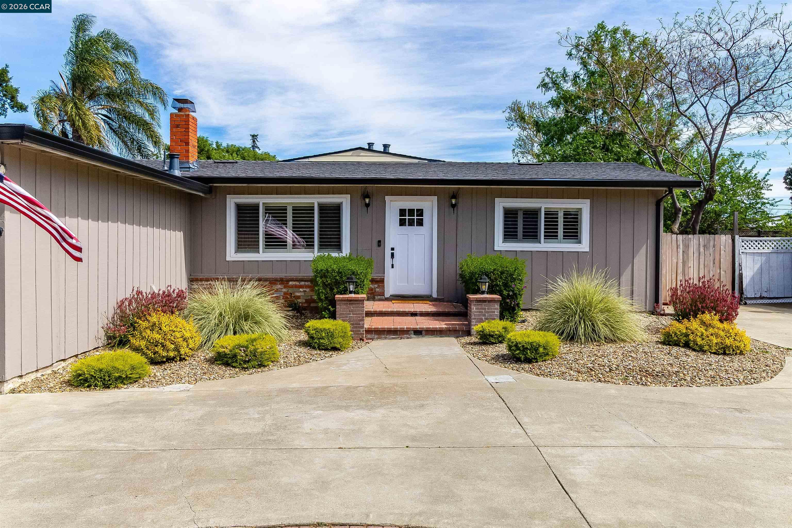 Welcome to this spacious and beautifully updated home, offering the perfect blend of comfort, functionality, and style. Featuring 4 bedrooms and 3 full bathrooms, this home is thoughtfully designed with room for everyone. A standout feature is the expansive additional living room, complete with vaulted ceilings, skylight, and direct access to the backyard, creating a bright and airy space ideal for relaxing or entertaining. The home also features canned lighting throughout, enhancing the modern feel, along with a freshly painted interior. The updated kitchen is equipped with stainless steel appliances and flows seamlessly into the dining area, where French doors open to the side yard—perfect for indoor-outdoor living. The primary suite offers a private retreat with a glass slider leading to the backyard, while two of the guest bedrooms include walk-in closets for added convenience. Three full bathrooms, including two showers, and one shower/bathtub combo. Step outside to your entertainer’s dream backyard, featuring multiple areas to gather, play, and unwind, including a deck, shaded pergola, large turf area, and spacious side yards. Additional highlights include a large U-shaped driveway, a 2-car garage with epoxy floors for plenty of parking. This home truly has it all!