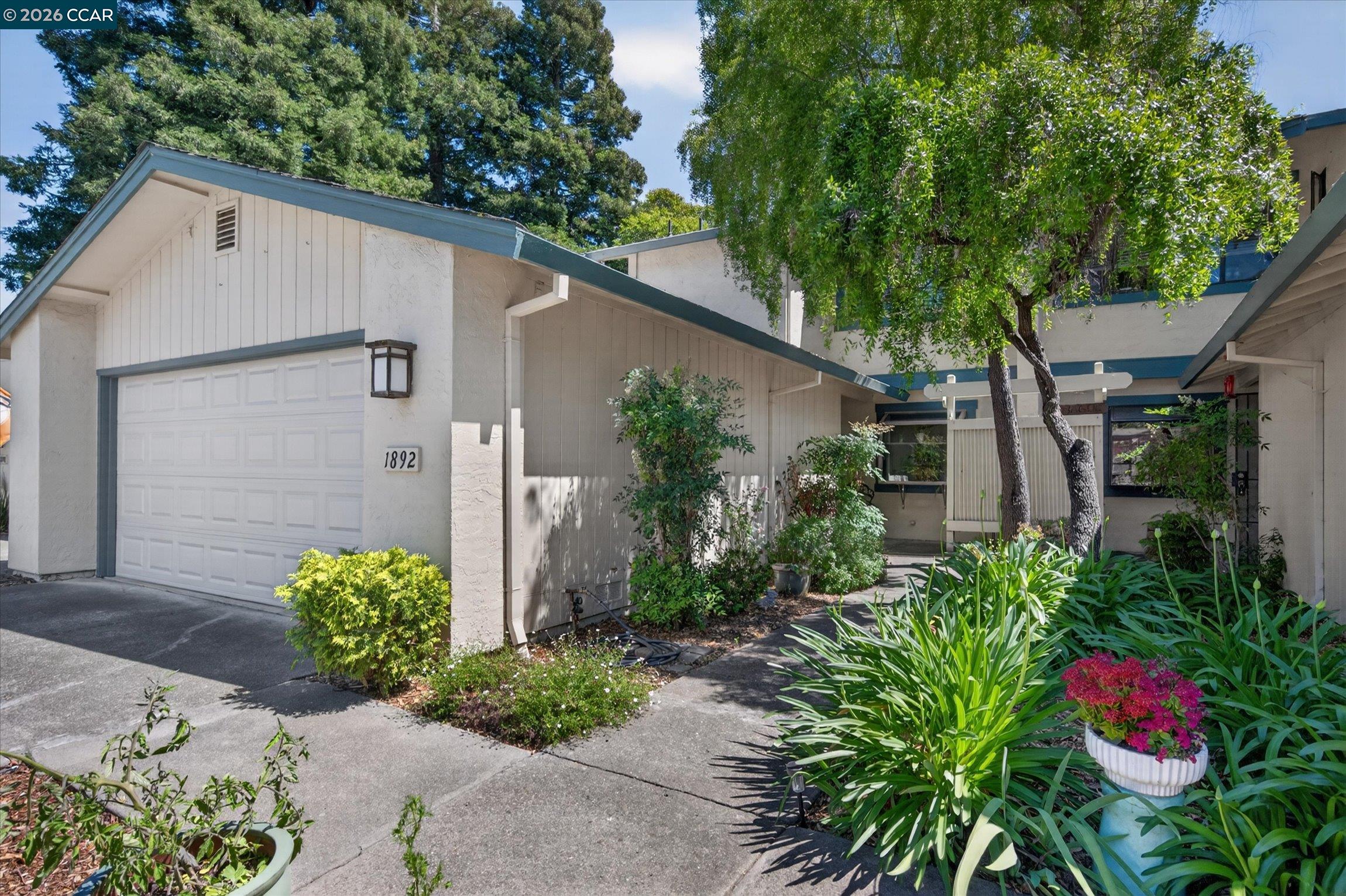 Enjoy the ease of single-family-style living with virtually no exterior maintenance—simply lock the door and go. Welcome to this beautifully upgraded home in Benicia's sought-after Bay Vista community. This thoughtfully updated residence features two spacious ensuite bedrooms, each with its own remodeled full bath.  The remodeled kitchen showcases brand-new luxury stainless steel appliances, an induction range, granite countertops, striking cobalt-blue cabinetry with pull-out shelving, a sunny breakfast nook, and new garden windows. White plantation shutters and attractive updated flooring enhance the home's stylish appeal throughout. The large inviting living room features a cozy fireplace, beautiful new tile flooring, and direct access to a charming cottage-style backyard filled with colorful landscaping—perfect for relaxing, gardening, or entertaining. An attached two-car garage offers abundant built-in storage. Additional upgrades include a new garage door, keyless entry, permitted new electrical sub-panel, storm door, attic fan, ceiling fans, and updated flooring in the main living areas. The Bay Vista HOA covers the roof, exterior maintenance, fencing, front landscaping, water, sewer, hazard insurance, and a community park, providing true low-maintenance living. Recent HOA improvements include exterior painting and a new roof. Ideally located near highly regarded Benicia schools, Benicia State Recreation Area, and vibrant downtown Benicia with its waterfront, shops, restaurants, galleries, and community events. Convenient access to Interstates 680 and 780, ferry service, and major Bay Area employment centers makes commuting a breeze. A rare opportunity to enjoy an upgraded, move-in-ready home in one of Benicia's most desirable communities.