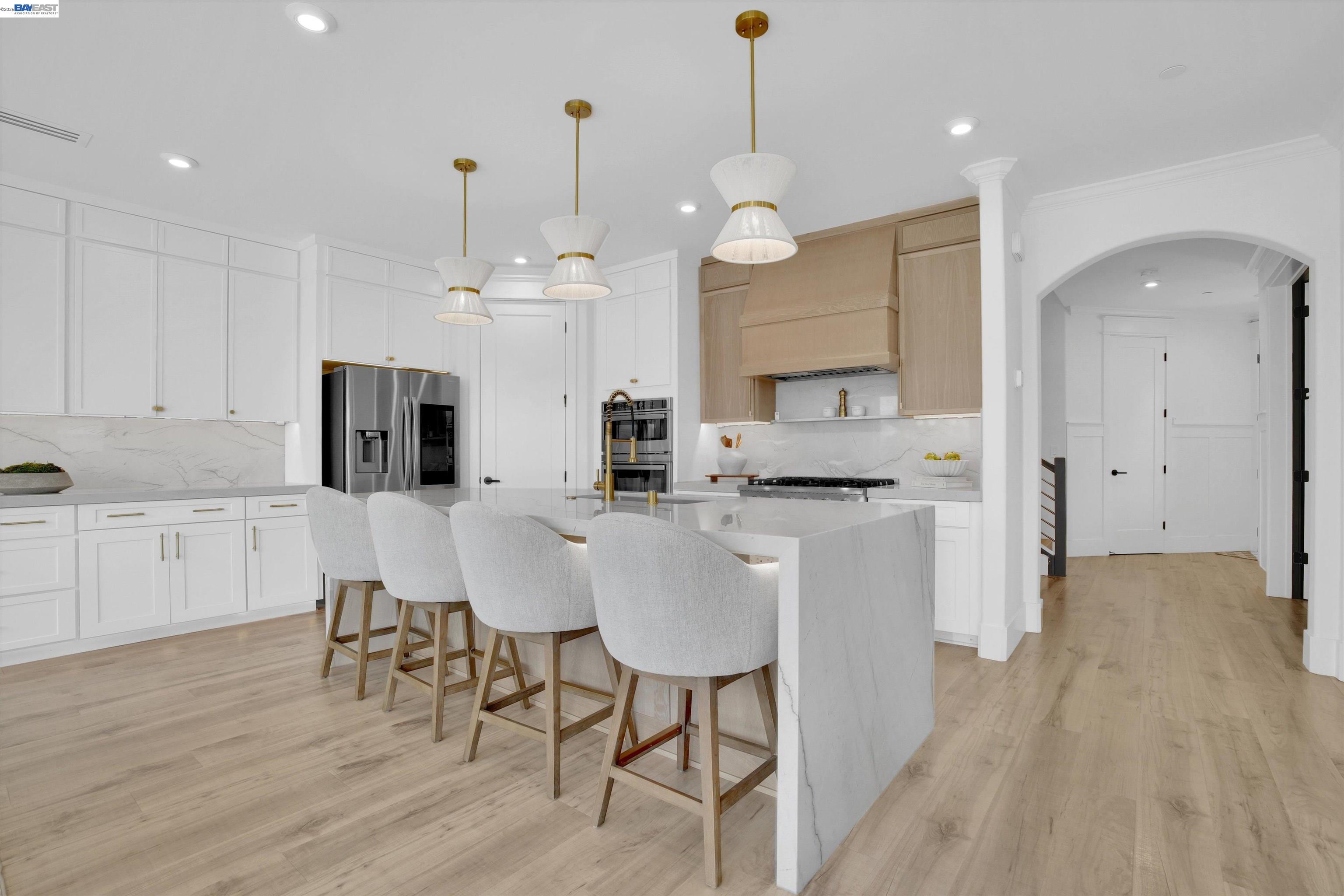 Recently renovated within the last few months, this truly one-of-a-kind modern luxury residence was designed with style, comfort, and functionality in mind. This beautifully updated 4-bedroom home features a versatile main-level bonus room perfect for a home office, guest suite, or a possible 5th bedroom, along with 3 full bathrooms including a stunning hotel-inspired downstairs bath ideal for guests or multigenerational living.  The show-stopping kitchen is the heart of the home, featuring custom white oak cabinetry, custom-fabricated quartzite countertops, and a dramatic waterfall island built for entertaining.  Designed to impress, the home showcases soaring 9-foot ceilings, smooth texture walls, curated LED lighting, and expansive double sliding doors that create seamless indoor-outdoor living. Step outside to a recently completed resort-style pool that makes every summer day the place to be while the home is filled with an abundance of natural light. Remote-controlled blinds add both convenience and privacy.  Adding to its unique appeal is the spacious 2-car garage plus an oversized RV garage, creating the perfect space for a workshop, gym, entertainment area, or car enthusiast’s retreat. A rare blend of modern luxury and everyday practicality with fully paid-off solar for added efficiency and value.