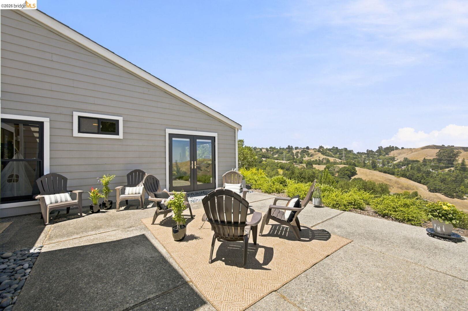 Nestled at the end of a quiet cul-de-sac in Moraga's desirable Ascot Highlands, this beautiful single-level offers a rare combination of expansive views, exceptional privacy, and effortless living. Enjoy sweeping panoramic vistas of rolling sun-kissed hills, blue skies, and spectacular sunsets that paint the landscape each evening. This townhome offers a level of privacy greater than many detached homes. Completely secluded back yard. Duplex style construction with only one common wall. No rear neighbors. Tour to appreciate. Inside, the home has been meticulously remodeled from top to bottom over the past 15 years with an emphasis on premium materials and quality craftsmanship. High-end wood windows, four sets of French doors, tile bathrooms, and rich genuine teak engineered hardwoods. The HOA pays water and maintains the community pool, roofs, gutters, siding, fencing, exterior paint, and landscaping for easy, low-maintenance living. Steps from hiking trails. Excellent schools.
