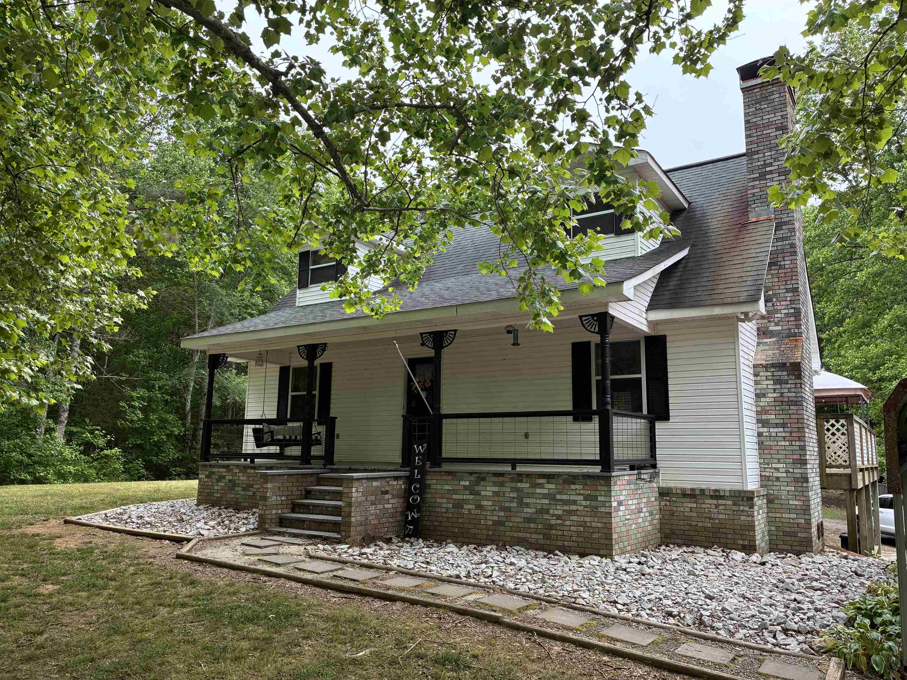 Welcome home to this 4-bedroom 2 bath multi-level country retreat nestled on a private 2+ acre wooded lot.  From the moment you arrive, y'all fall in love with the gorgeous front porch complete with a charming swing.  Just the perfect place to relax and enjoy the peace and quiet.  Inside this home offers multiple levels of comfortable living space, providing 2 bedrooms on the main level, 1 bed bedroom upstairs and another possible bedroom in the finished basement.  The wooded setting provides privacy and a serene atmosphere while still offering all the comforts of home.  If you've been searching for a peaceful escape with all the classic country charm this is the home.
