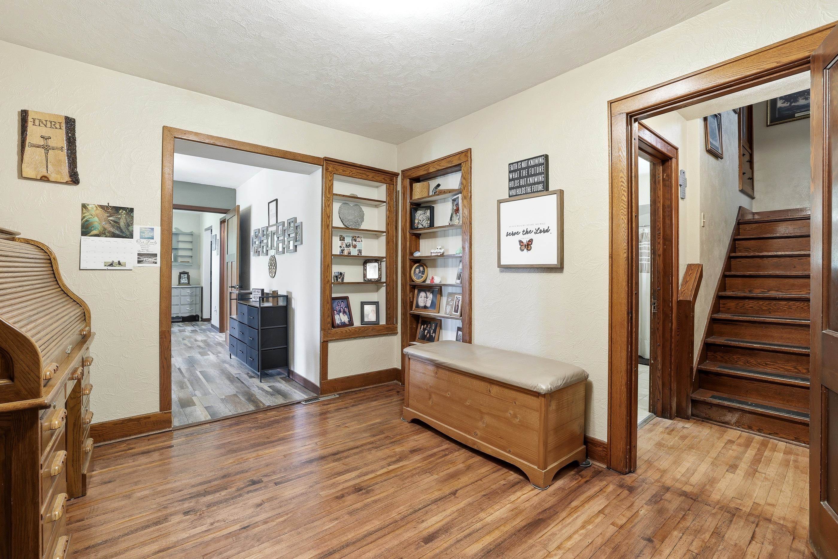 View to the 1st floor full bathroom to the left. Stairs going up. Pantry door to the right.
