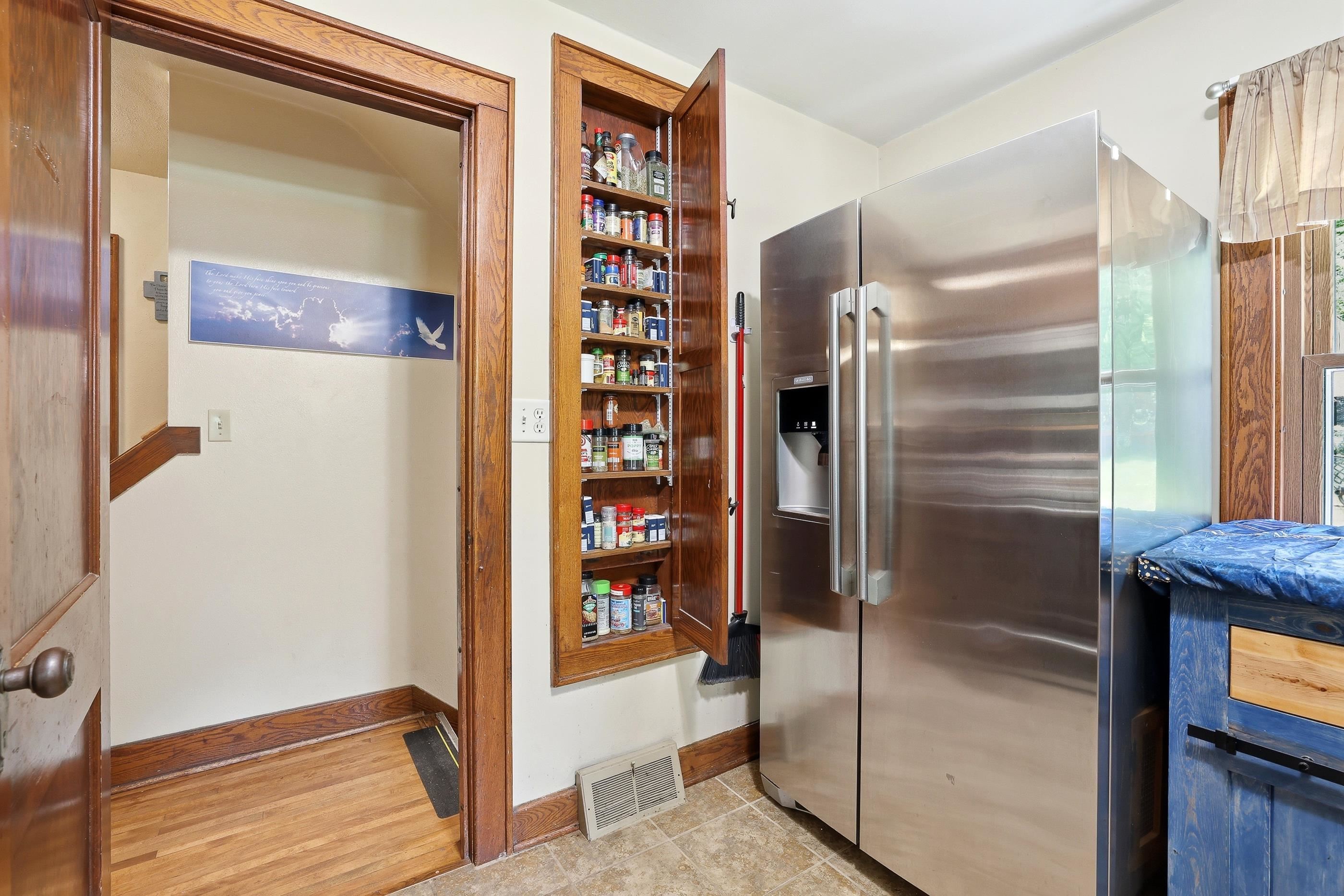 Built in spice cabinet. The view is towards the hall that also has built in pantry.