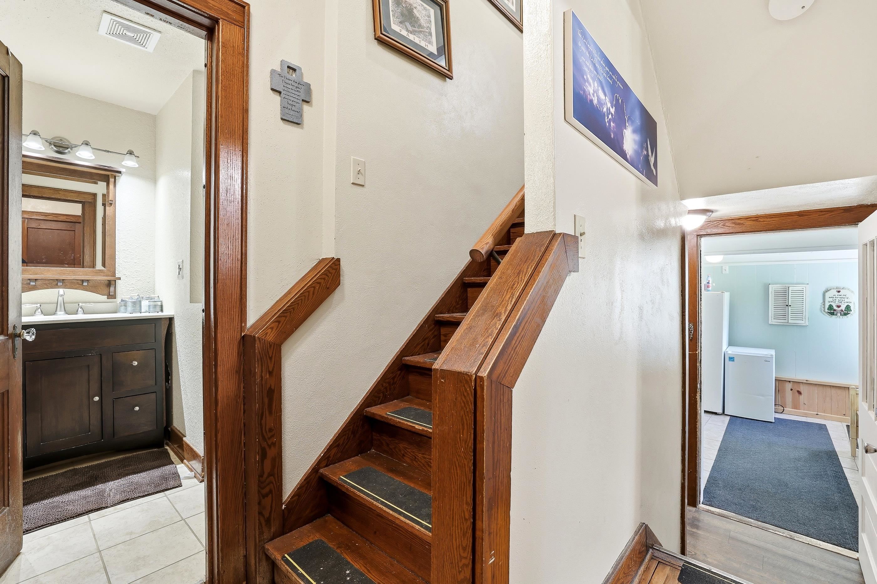 This hallway goes towards the mudroom and the basement stairs.