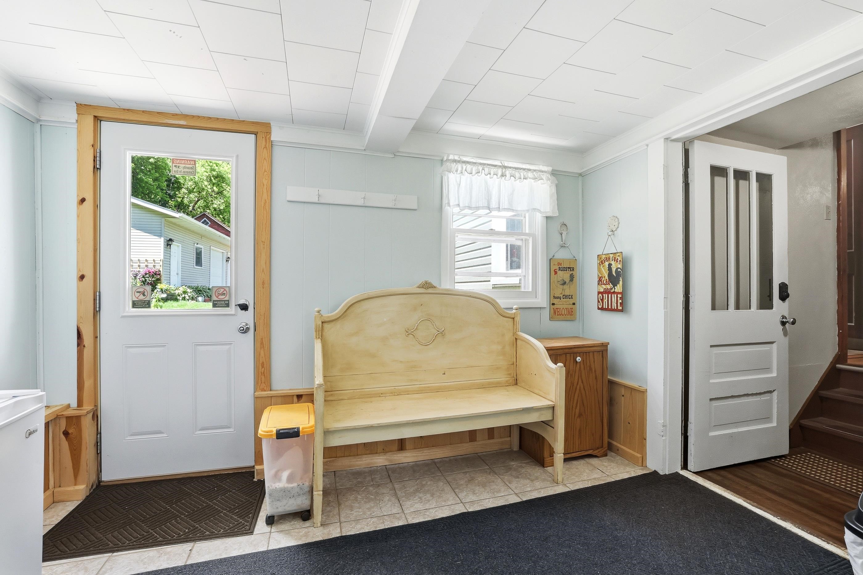 Shows the door to the outside towards garage.