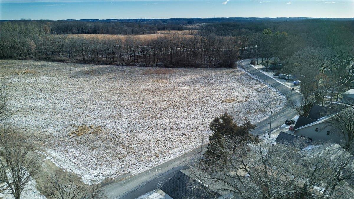 Bring your imagination and creativity to this exceptional 7.85-acre parcel located directly across the street from Lake Kegonsa, adjacent to Lake Kegonsa State Park, and on the lower Yahara Bike Trail. The property offers both near-term and long-term development potential, with initial conversations  indicating the site may support approximately 15 lots, including elevated homesites with year-round Lake Kegonsa and sunset views.  Several potential lots also overlook the sweeping Door Creek Wetlands and the nearby Lower Yahara Bike Trail, creating a rare combination of water, open space, and recreation. Soil tests have already been completed in preparation for future development and are available for review.  Develop immediately, or build your own private residence and hold the remaining land as a long-term investment in the continued growth of Dane County.