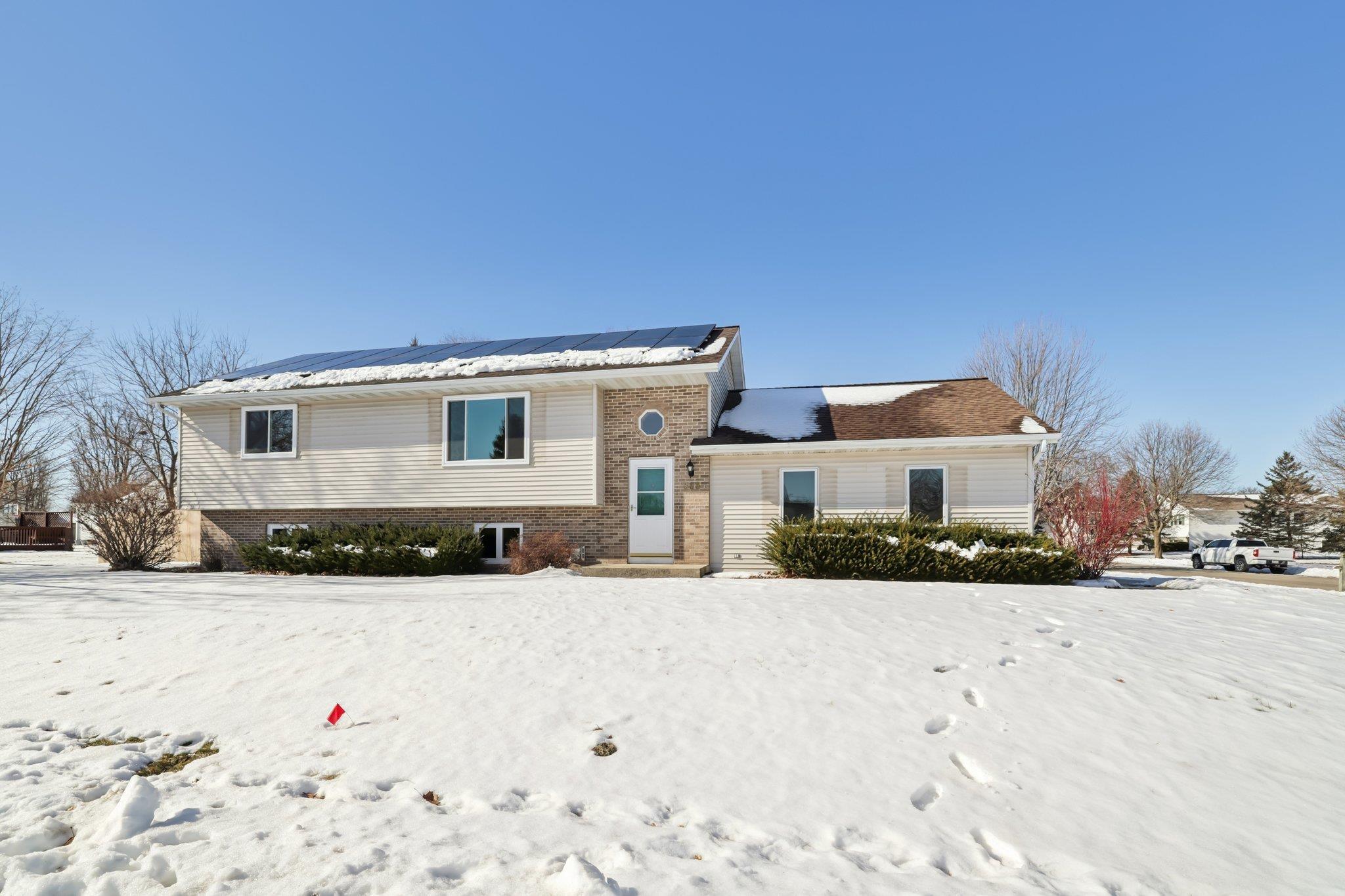 Rare West Sun Prairie find in Royal Oaks district across from Gateway Park! OWN your home's power- This high-efficiency gem features approx $50k in PAID solar (est $100/mo savings). Further peace of mind w/$21k in NEW windows (late 2025), fresh interior paint (12/25), & a Home Warranty thru 8/27. The main level boasts real wood floors & a sunny kitchen w/slate appliances, 4-top breakfast bar, & pantry. King primary suite offers dual step-in closets w/organizers. LL includes a cozy family room w/gas fireplace, wet bar w/fridge, & a king-sized 3rd BR with dual closets. Amazing 3-tier deck overlooks a new $9k professional 6' privacy fence (2025). Insulated/sheetrocked 2-car garage has epoxy floors, attic storage, & new opener. Mechanical updates: new washing machine (2026), furnace motherboard/gas valve (2025), water heater (2024), owned softener, and 200 amp service. Duct cleaning recently done and garage keypad added 2025. Updated baths with new toilets, faucets, and shower surround.