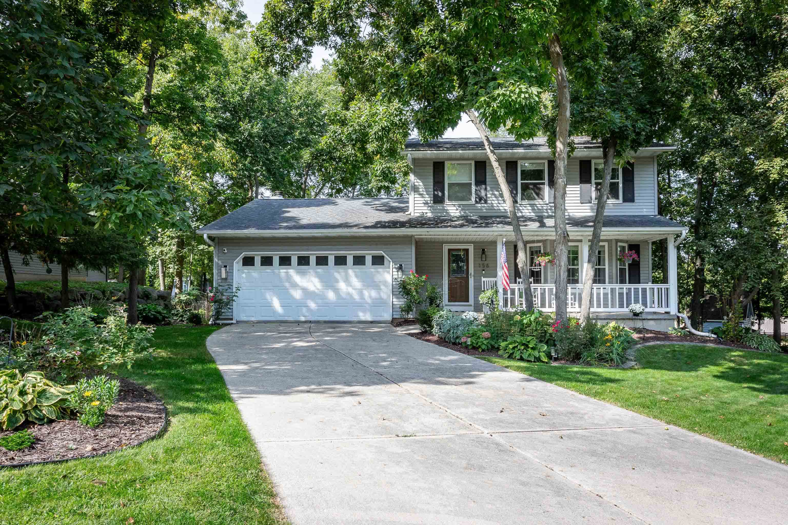 Nestled on a wooded cul-de-sac, this picture-perfect 3-bedroom, 2.5-bath home offers an inviting layout and thoughtful updates throughout. The freshly painted interior and gleaming wood floors create a warm first impression. A bright front living room flows into the dining area, where bay windows overlook the lush backyard. The updated eat-in kitchen features quartz countertops and a classic subway tile backsplash. The cozy family room with wood-burning fireplace opens to an incredible sunroom and deck, perfect for enjoying the private, fenced yard. Upstairs you'll find two spacious bedrooms, a full bath, and the primary ensuite. The finished lower level rec room walks out to a beautiful paver patio with a built-in firepit - ideal for relaxing or entertaining. Don’t miss this gem!