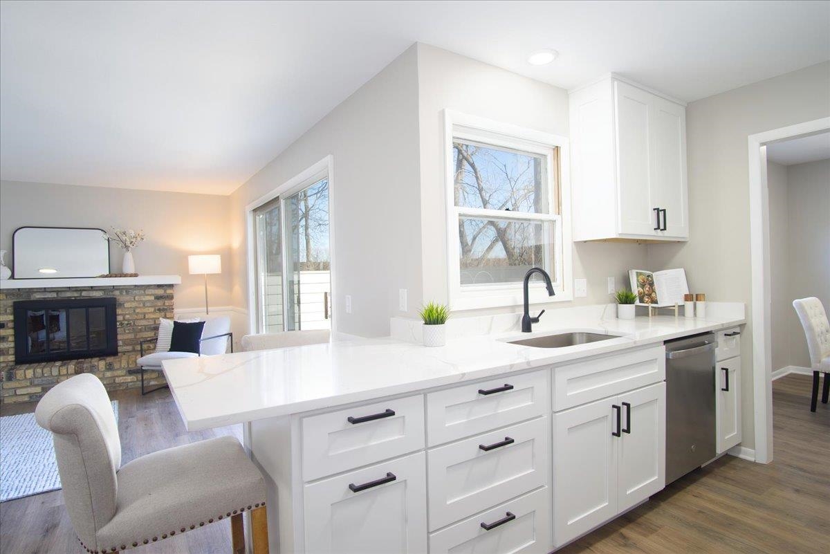 Fully remodeled in 2026, this spacious 3-bedroom, 2.5-bath condo offers true turnkey living with high-quality finishes throughout. The stunning kitchen features custom Amish cabinetry, quartz countertops, & all new appliances, & opens to a breakfast nook & family room with a cozy wood-burning fireplace & sliding glass doors leading to the private fenced patio. A more formal dining room connects to the spacious living room, creating an ideal layout. Throughout the home you'll find new flooring, fresh paint, updated light fixtures, new plumbing fixtures, and beautifully remodeled tile showers & baths with new vanities. All three generously sized bedrooms are located upstairs, including the primary suite with an oversized walk-in closet. Additional updates include a new furnace &  AC. The home also features a fully screened front porch & a large unfinished basement for storage or expansion, all within a well-maintained condo association with professional management.