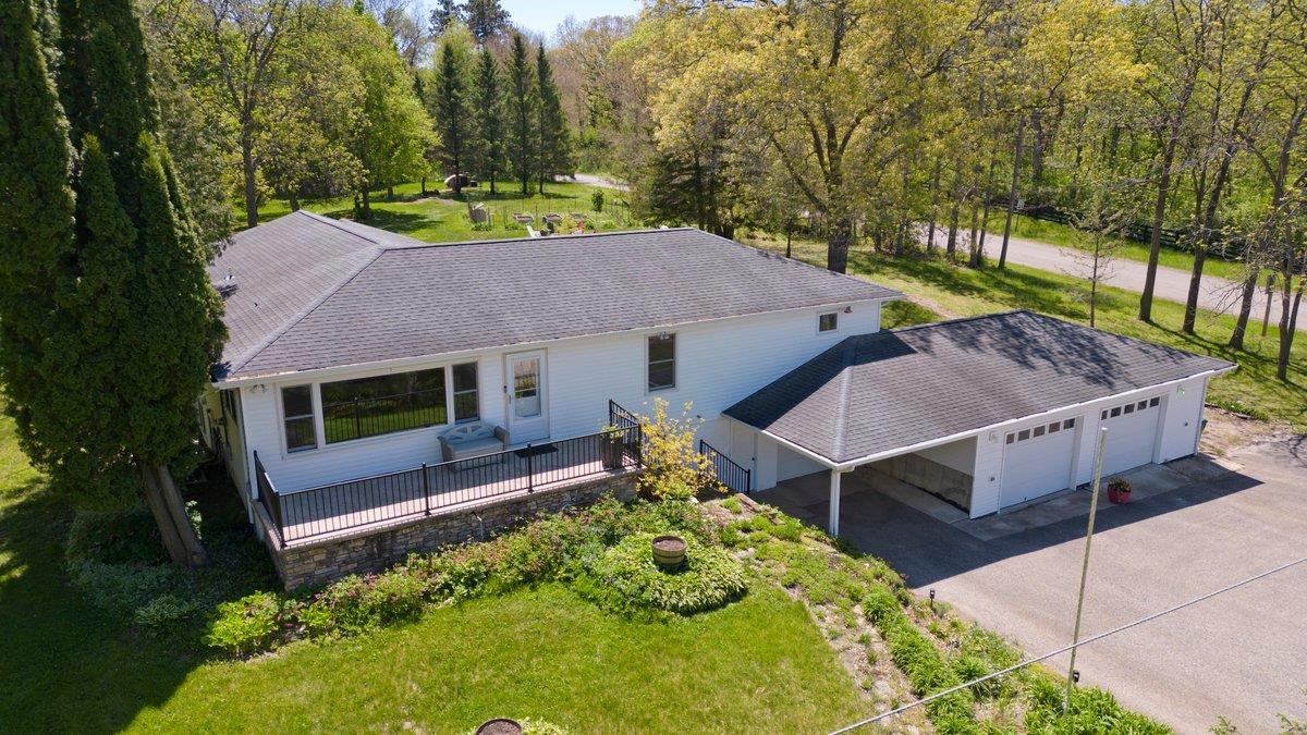Show 5/15. Escape to country living in this inviting ranch home with an exposed lower level set on nearly 2 acres. This home is spacious & comfortable with breathtaking views in every direction, offering the perfect blend of warmth & functionality. The great room opens to a thoughtfully designed kitchen & overlooks the backyard. The cook will appreciate the hickory cabinetry, large island, & pantry; ideal for everyday living & entertaining. Just off the kitchen is the versatile dining room featuring custom built-ins. Unwind in the 3-season room while enjoying peaceful views of nature year-round. The exposed lower features 2 beds, a full bath + a massive rec room, offering plenty of flexible living spaces. The attached 3-car garage + carport ensures there's room for cars, storage, & hobbies. Outside, the expansive yard is perfect for recreation, gardening, & outdoor fun. Enjoy harvests from the raised garden beds & evenings around the fire pit. Just minutes from Lake Waubesa & Madison.