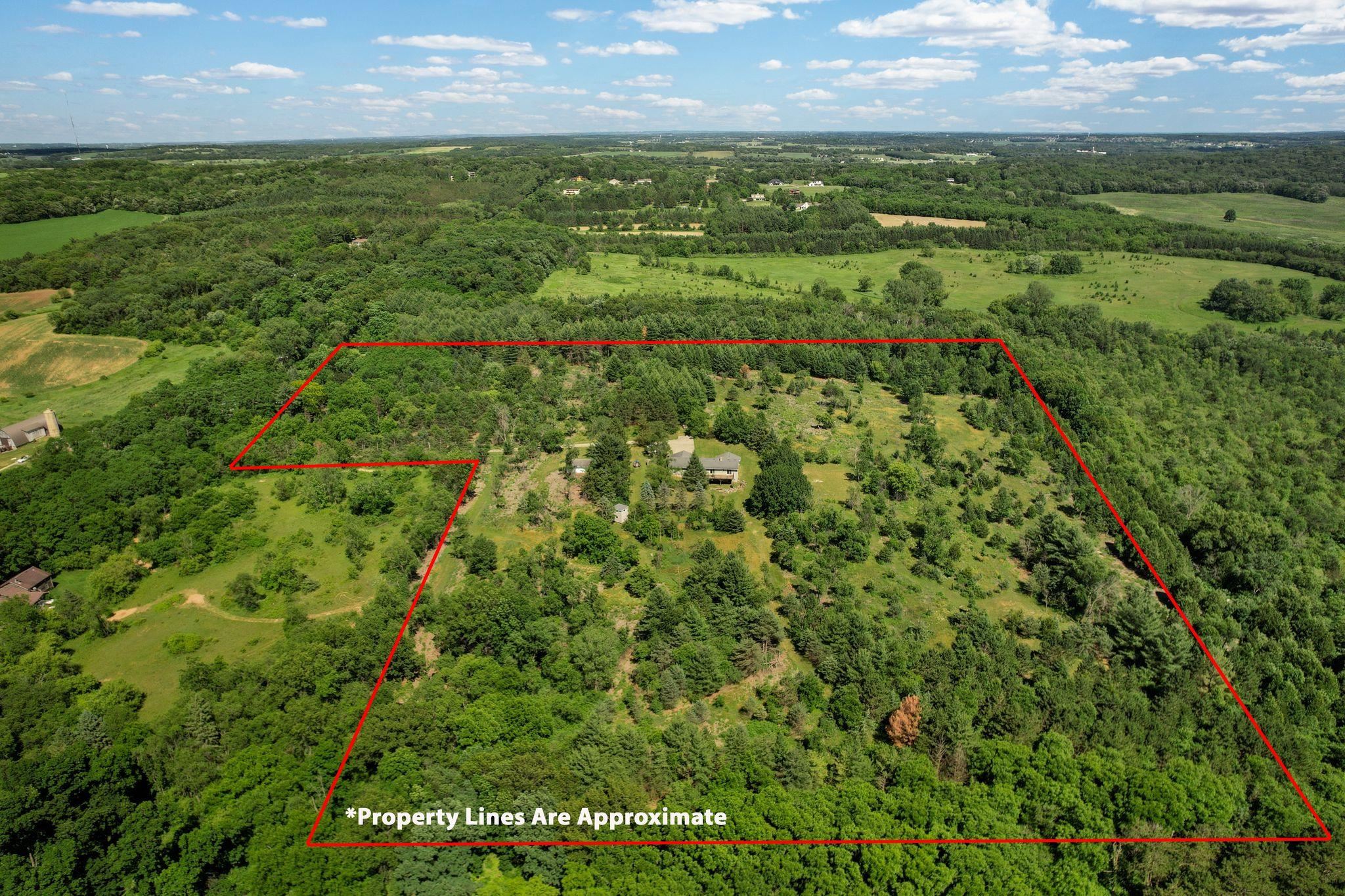 A truly rare Town of Verona acreage offering: 26.7 private acres positioned at one of the highest points in Dane County. Set at the end of a long private driveway, the property offers a beautiful blend of mature hardwoods, evergreens, open space, and natural habitat. Wildlife is abundant, with deer, turkey, songbirds, and more regularly seen throughout the property. The setting feels peaceful and secluded, yet the location is remarkably convenient - less than 10 minutes to downtown Verona and under 20 minutes to downtown Madison. According to the Town of Verona’s land use plan, the site may allow for division into 2-acre buildable parcels, creating compelling long-term flexibility. Recent sales of similarly private, wooded lots in the Town of Verona have exceeded $400,000, highlighting the strength of the underlying land value. Existing residence, garage, well, septic, driveway, and utilities are in place, but the true value is in the land, privacy, location, and future possibilities.