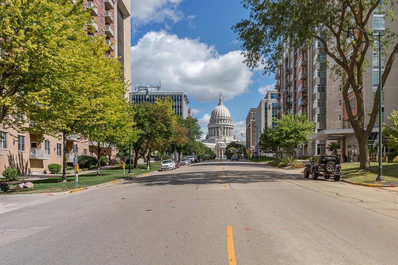Show 6/26. ?Rare opportunity at Metropolitan Place! Freshly painted 2 bed, 2 bath condo with gleaming hardwood floors in the heart of downtown Madison with Capitol views & a coveted south-facing exposure that fills the home with natural sunlight.  Just blocks to the Capitol Square, State Street, Overture Center, UW, restaurants, shops, lakes, farmers market & Concerts on the Square. Enjoy secure building access, professional onsite management, fitness room, rooftop courtyard/garden, guest parking, EV chargers, dog run & more. What truly sets this home apart: 3 covered parking stalls plus an unheard-of 8 storage units. Keep them for personal use, rent them, or sell separately - parking stalls in the building have reportedly sold for $20K–$30K each.