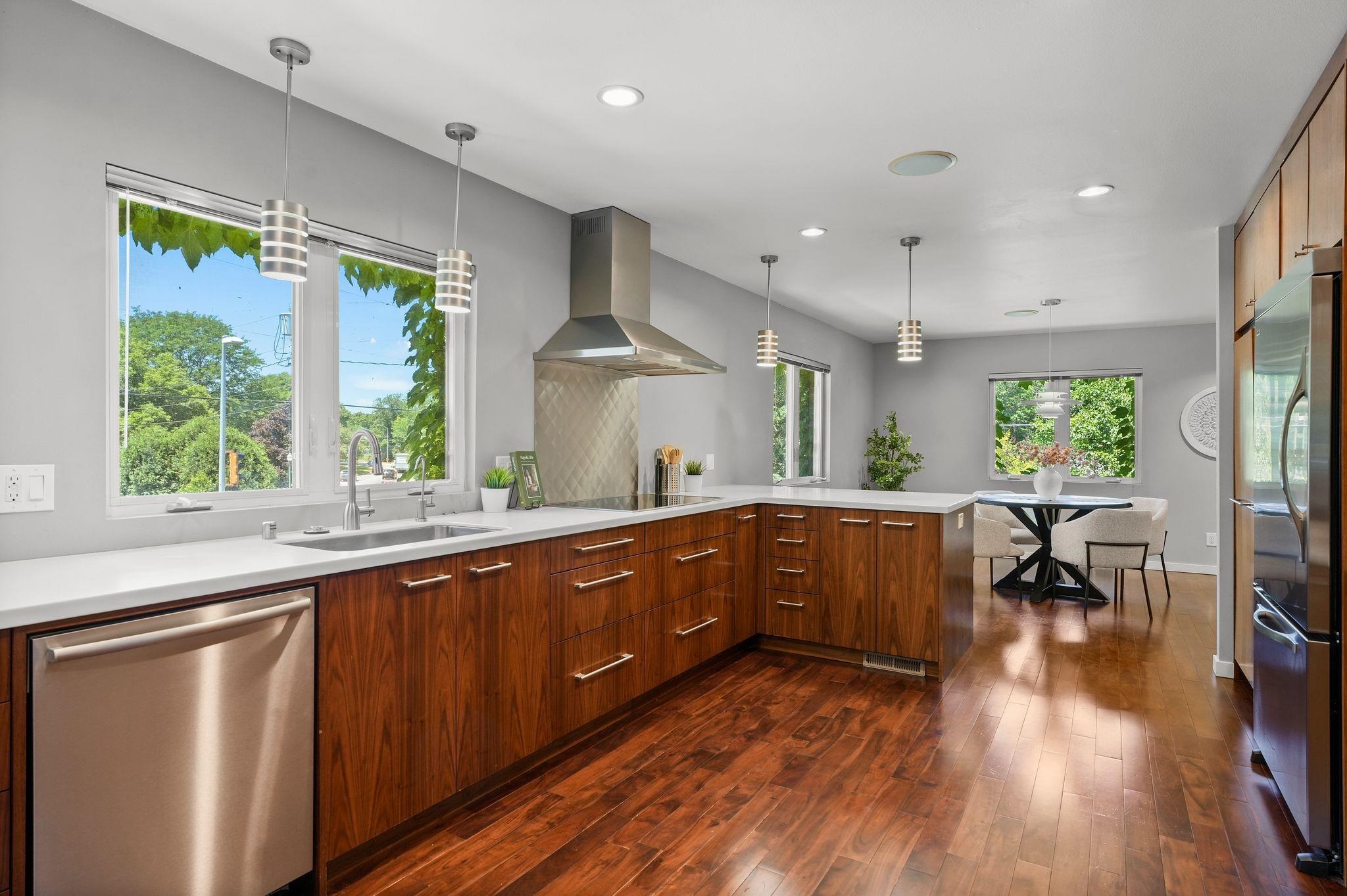 Stunning all-brick home in the heart of Madison!  Just across from Tenney Park, a short walk to Breese Stevens Field, Willy Street Co-op, an incredible selection of restaurants, & neighborhood amenities. Thoughtfully renovated down to the studs, the main level features solid walnut floors, a spacious gourmet kitchen with custom walnut cabinetry, Bosch double ovens & dishwasher, induction cooktop + Viking refrigerator.  The two great first floor bedrooms utilize the two well appointed bathrooms - including a five-head Kohler walk-in shower, & an oversized soaking tub. The finished lower level offers two additional bedrooms/offices, a full bath, rec room, & laundry. Recent updates include a brand-new roof in 2026, select new flooring, fresh paint, +more. Detached two-car garage & parking for 3 additional cars complete this exceptional property.