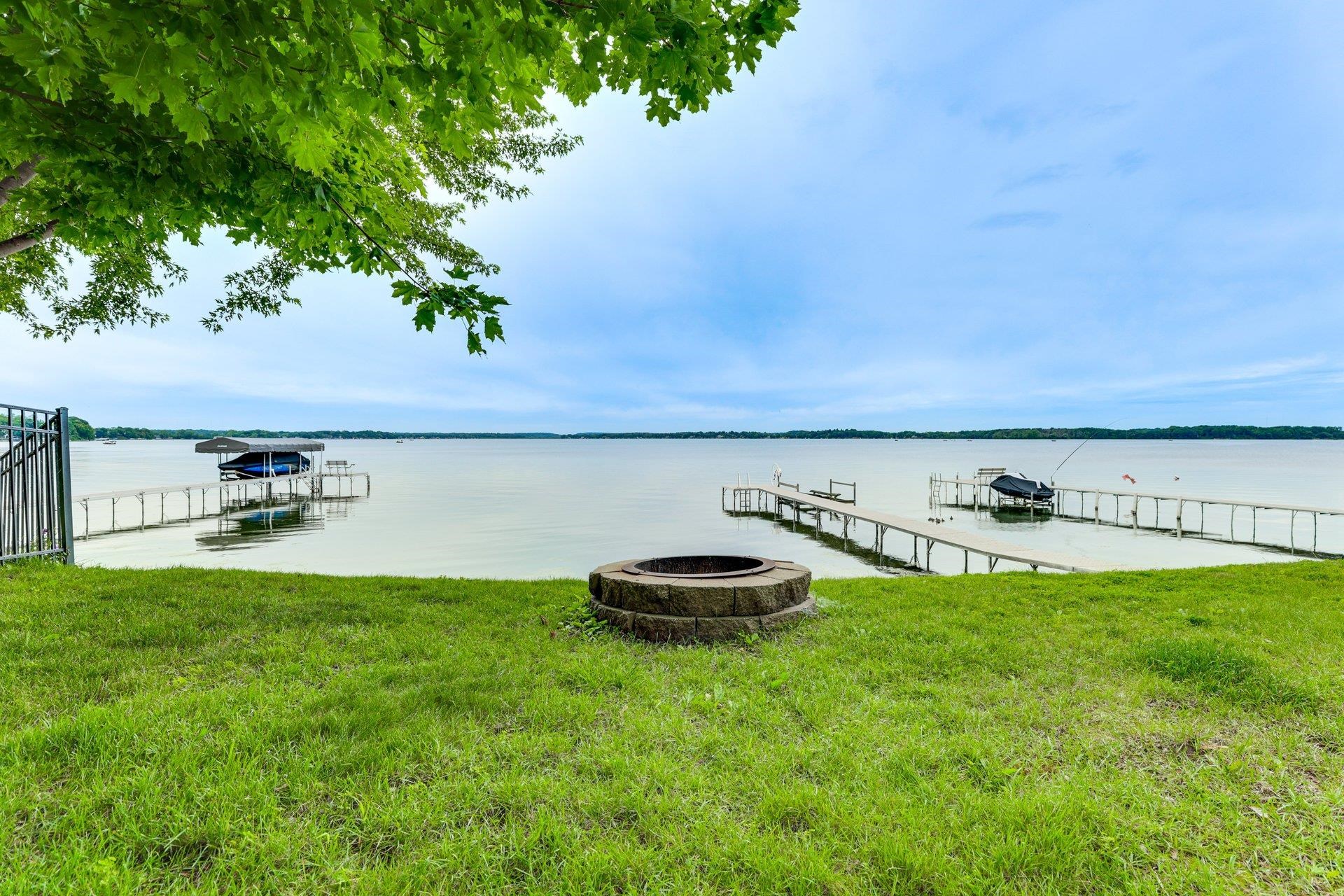 Delayed until 9/4 for staging & photos, Show 9/4. Enjoy lake living on Lake Waubesa with private frontage, a dock, shallow sandy-bottom swimming and beautiful sunset views. This 3-bedroom, 3-bath home blends character with thoughtful updates, including an updated kitchen with granite counters and breakfast bar, updated bathroom, two gas fireplaces, first-floor laundry and a sunroom overlooking the water. A generously sized attached 2-car garage adds storage for lake gear, while the partially finished lower level offers additional space including a historic bar. Boat lift, sauna and furnishings are negotiable. Just minutes from downtown McFarland and about 15 minutes to Madison.