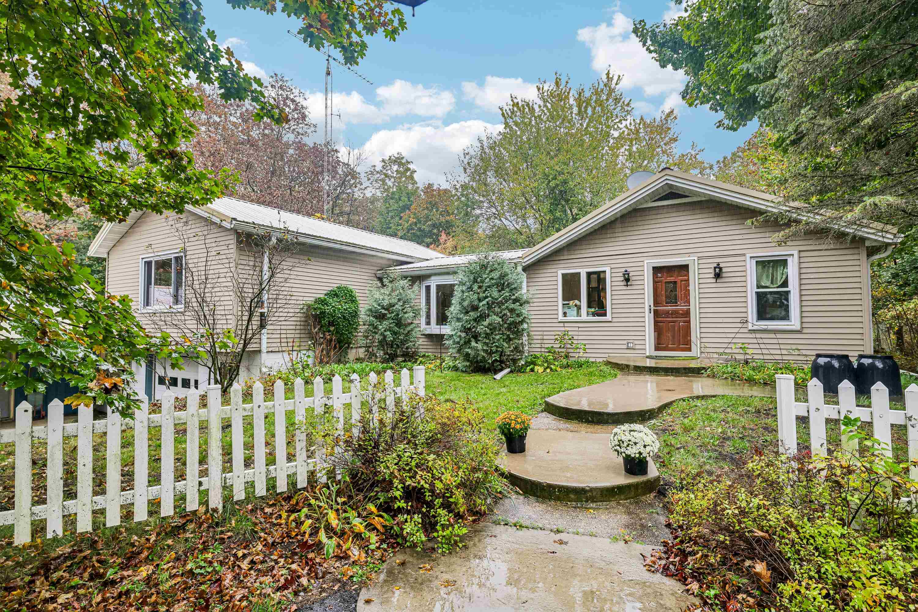 Lovely 3 bedroom Ranch home w/10.56 gorgeous acres! 1-car extra deep attached garage, plus 20x24 garage & 16x45 back shed. Newer 4-season room w/knotty pine cathedral ceiling & amazing views! Kitchen was completely remodeled w/gorgeous red quartz countertops & Amish-made Alder cabinetry. 2 Kitchen pantries, newer SS Appliances. Wonderful large island offers extra cabinets & seating. Dining area w/big, bright bow window. Main level fam room or formal dining room w/pocket french doors. Large living room has cozy wood burning stove. Stained glass windows in living room included. Freshly remodeled Bathroom (new 5 years ago) w/lrg tile shower & custom seat. Main level laundry Updated flooring, newer windows. Re-Insulated attic, Updated electrical system. Metal roofs on home & garage, Septic new approx 2022. Private backyard faces South. 2 separate tax parcels - 1 could be a separate building site! Close to boat ramp to Fox River & walking trails at John Muir Park. Only 9 miles N of Portage!