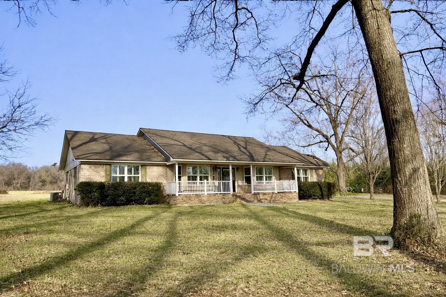 Situated on over 6½ acres, this beautiful 3 bedroom, 3 full bath home offers space, functionality, and timeless charm. Split brick floors welcome you into an open kitchen and den, complemented by a separate dining area perfect for gatherings and entertaining. A designated office provides the ideal work-from-home setup.The primary suite is thoughtfully designed with an oversized walk-in shower, two separate dressing areas, and two walk-in closets, creating both comfort and convenience.Step outside to a covered back patio overlooking peaceful surroundings. The property also features a barn complete with horse stalls and additional storage, making it ideal for animals, hobbies, or extra workspace.A rare opportunity to enjoy country living with room to roam while still having all the comforts of home! Let's go look! Buyer to verify all information during due diligence.