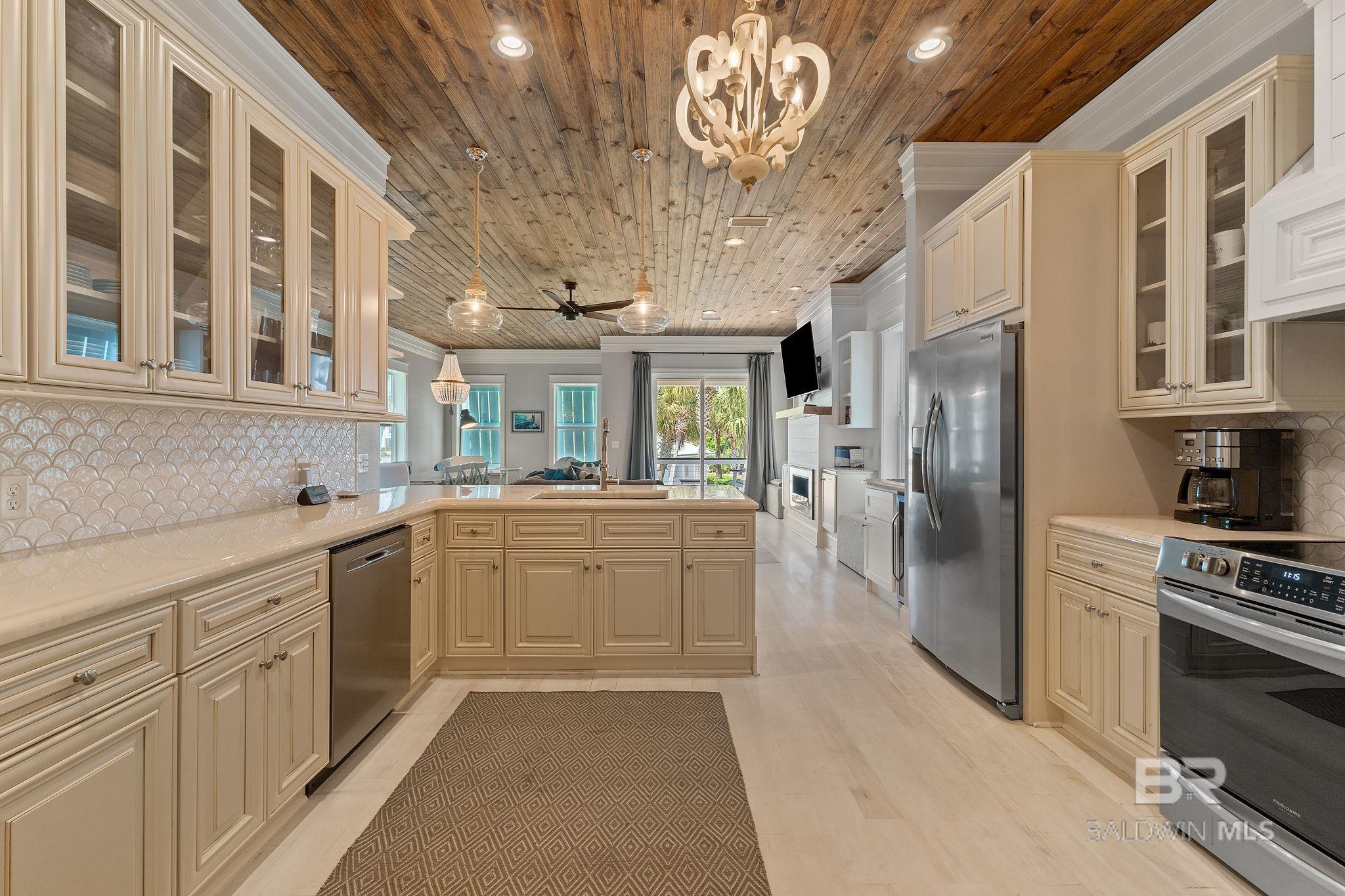 New BOAT SLIP on close to 100' of the intercoastal included! Welcome to Mallory Square North, where Key West charm meets luxury coastal living in Perdido Key. This stunning freestanding home is located in a gated community just across the street from the sugar-white sands of the Gulf, offering the perfect mix of beach days and boating adventures. A rare highlight of this unit is the designated boat slip on Ole River, plus an oversized private storage/garage space large enough to store a boat—ideal for boaters and anyone needing extra room for beach gear, paddleboards, and fishing equipment. Inside, enjoy a spacious 4-bedroom, 4.5-bath layout with every bedroom featuring an ensuite bathroom for ultimate privacy. The open-concept living area is made for entertaining with a gas fireplace, wet bar, and wine fridge. The kitchen shines with custom cabinetry, a large pantry, and stylish concrete countertops. Upscale finishes include 10’ ceilings and 8’ doors on the main level, tongue-and-groove ceilings, crown molding, hardwood floors, and tiled showers throughout. A bonus bunk room offers extra sleeping space, while the primary suite features a gas fireplace, walk-in closet, and spa-like bath with a soaking tub and separate shower. Enjoy resort-style amenities including a community pool with sun shelf and beautiful Ole River views. Outdoor living is easy with an outdoor kitchen (built-in grill + sink) and an outdoor shower for rinsing off after the beach. Parking is a breeze with under-unit parking plus the detached storage/garage. Located just 1 mile from Flora-Bama, with quick access to dining, entertainment, and the best of Perdido Key waterfront living. Buyer to verify all information. Buyer to verify all information during due diligence.