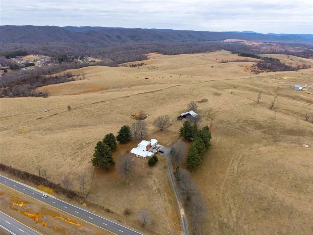 Welcome to your private country estate! This stunning 5BR/5BA brick home offers 4,611 sq ft of beautifully designed living space on 20 rolling acres of fenced pastureland. With a new metal roof and a layout ideal for dual-family living, this home blends comfort and flexibility. A 2,400 sq ft barn complete with power and water—perfect for livestock, hobbies, or equipment. As a farmer would say, the new fencing on the back lot is ''horse high, pig tight, and bull strong''. Gather friends and family in the expansive concrete courtyard and enjoy peaceful farm views in every direction. This is country living at its finest with quick access to Dublin, Pulaski, and I-81 within minutes.