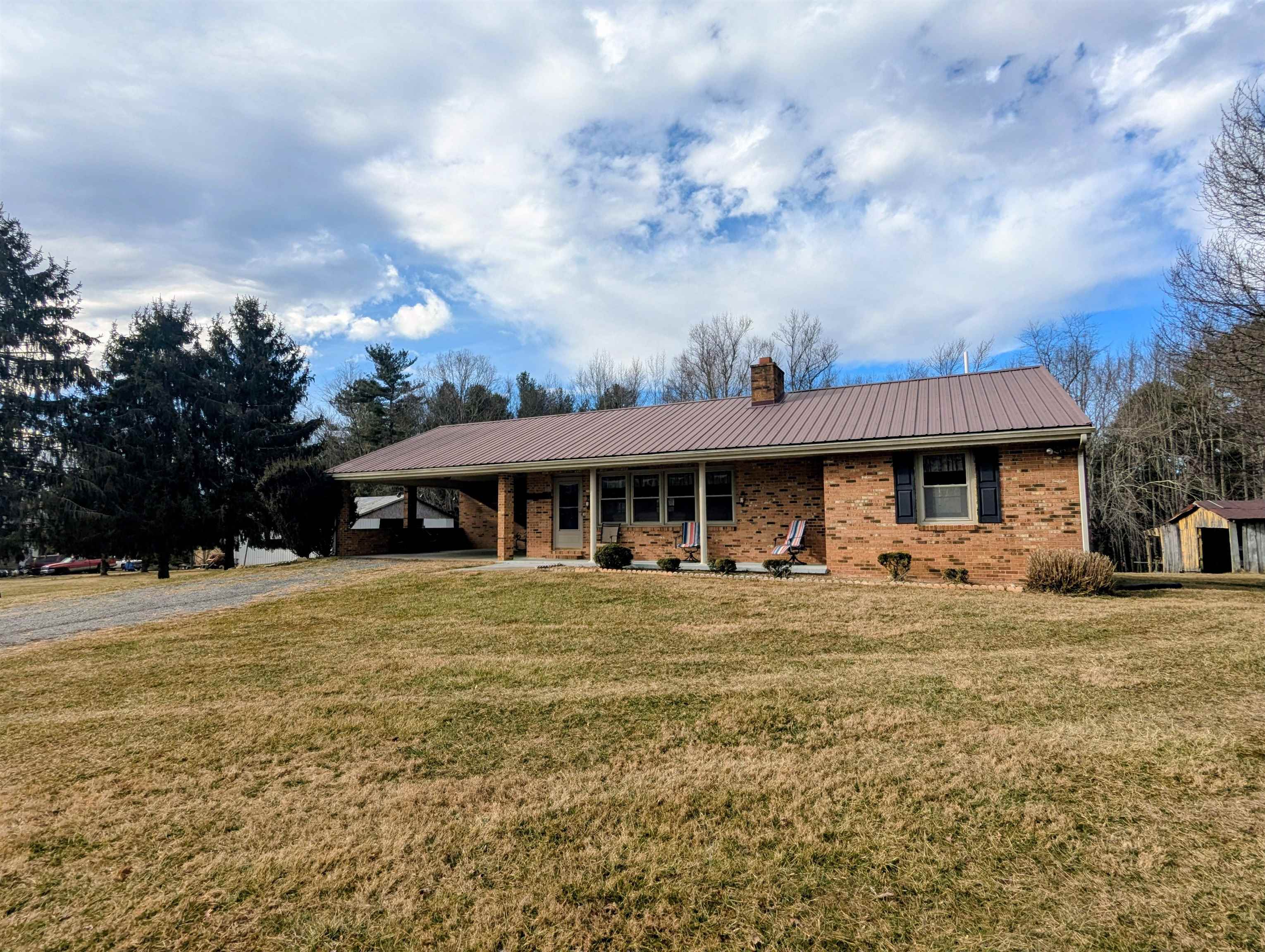 Brick ranch with 7.97 acres less than five minutes from the Town of Floyd VA!  It's becoming a rare find to locate both a home and acreage close to town.  Built in 1980 this solid brick ranch home showcases a modern kitchen, ample dining and living room space with 3 BDR, 2.5BTH.  Having the laundry, bedrooms and 1.5 baths on the main level this home works well for any stage of life. An unfinished basement complete with a cellar for your canned goods provides extra storage capacity.  Additionally several outbuildings compliment this property. The driveway is level and easy to access with open pasture in front of the home ready for your livestock!! Fiber internet available!!