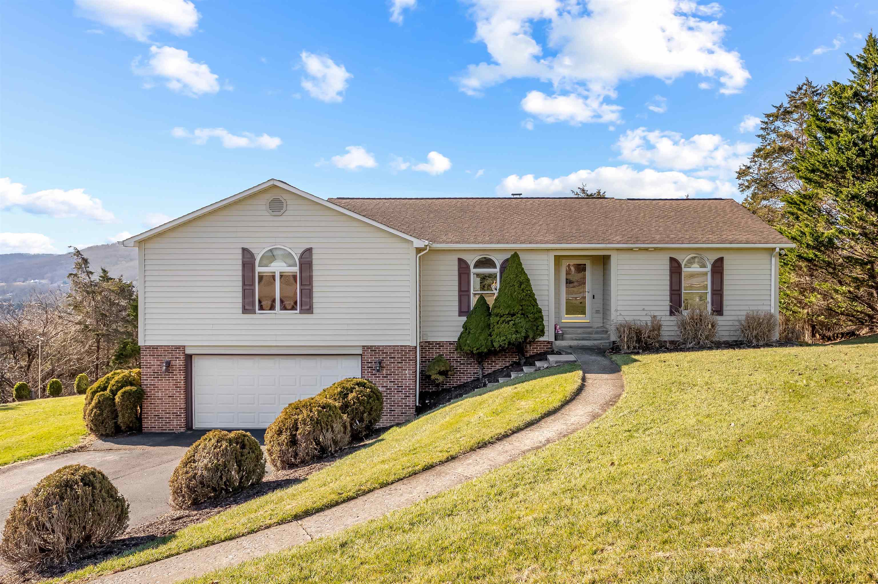 Looking for a home with amazing views and plenty of space? This four-bedroom, three-and-a-half-bathroom house on Mountainside Dr has you covered with comfortable living in one of Blacksburg's best spots. You'll love the beautiful hardwood floors running through the main level—they just make everything feel cozy and welcoming. The sunroom is a real gem with those mountain views, perfect for your morning coffee or just unwinding after a long day. And when it gets chilly, the fireplace is the ideal spot to kick back and relax. The basement rec. room is a great entertainment space—perfect for movie nights, game day gatherings, or just hanging out with friends. Plus, the large deck is perfect for soaking in those stunning mountain views any time of year. Golf fans will appreciate being close to Blacksburg Country Club, and Virginia Tech is just a short drive away for games, events, and more. This one's got it all—space, views, and a great location in the New River Valley.