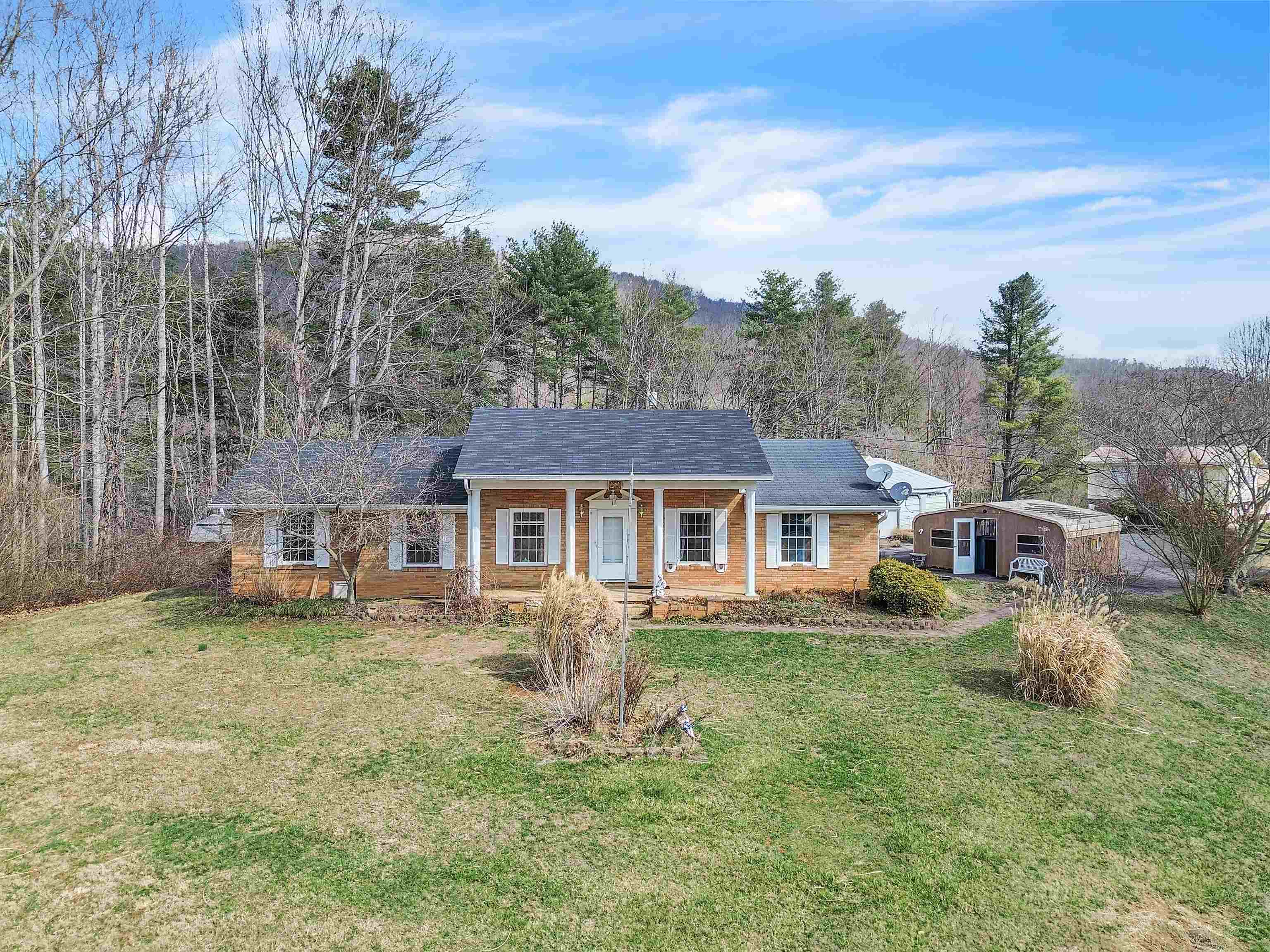 Welcome to 92 Fawn Lane in Rocky Gap, Virginia—a charming and well-loved brick ranch that offers comfort, space, and a peaceful country setting. As one of the first homes built in this established subdivision, this property sits on approximately 1.5 acres and has been thoughtfully cared for through the years. The home features three bedrooms and two bathrooms, along with a warm and inviting living room that flows seamlessly into a dedicated dining room, creating the perfect setting for family meals and gatherings. Just off the dining area is a generously sized bonus room previously used as a den, offering flexible space that could easily serve as a fourth bedroom, or home office. The home is equipped with electric heat and is serviced by well and septic. Outside, you’ll find a spacious yard and several outbuildings, ideal for storage, hobby area, or workshop space. Schedule your showing today and experience the charm of 92 Fawn Lane for yourself.