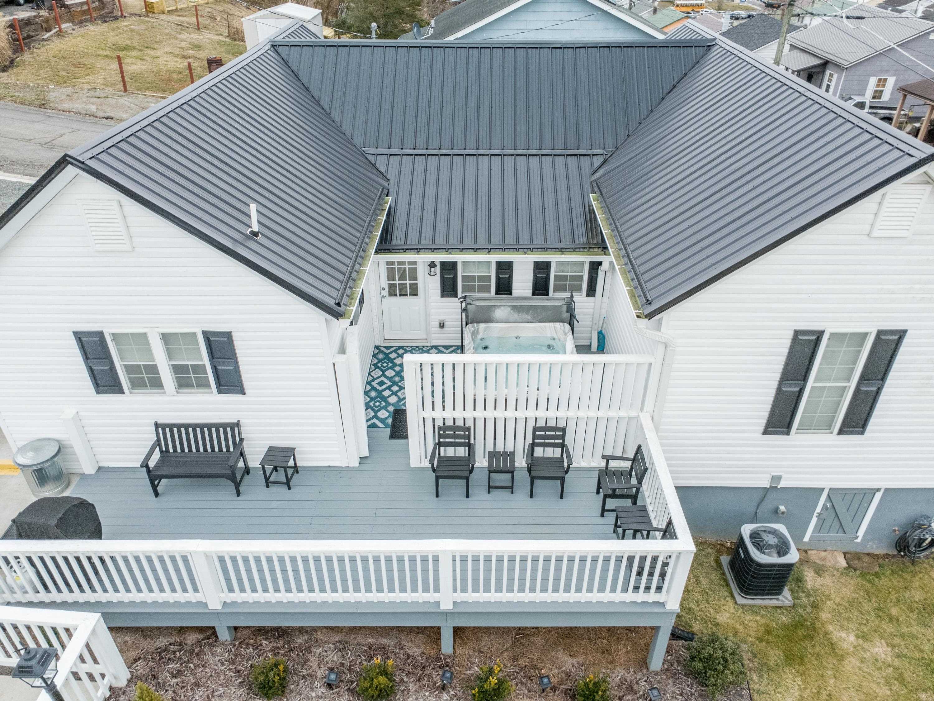 Own a beautifully restored piece of Fries, VA history. This completely renovated 2-bedroom, 2-bath mill home offers 1,180 sq ft of charm blended with modern upgrades. The spacious gourmet kitchen features stainless steel appliances, a cozy coffee bar, and scenic views. Decorative tile accents throughout create a bright, welcoming atmosphere. Enjoy peaceful mornings on the front porch or relax in the jacuzzi overlooking the Fries Dam. Additional highlights include a gas fireplace, full-size washer and dryer, custom blinds, a deck with fire pit, and generously sized bedrooms, including a primary suite with private ensuite bath. Walk historic sidewalks once used by mill workers to nearby restaurants, picnic areas, the New River, and the New River Trail. Originally two mill homes combined into one spacious residence, this property offers flexibility as a full-time home, weekend retreat, or investment opportunity.