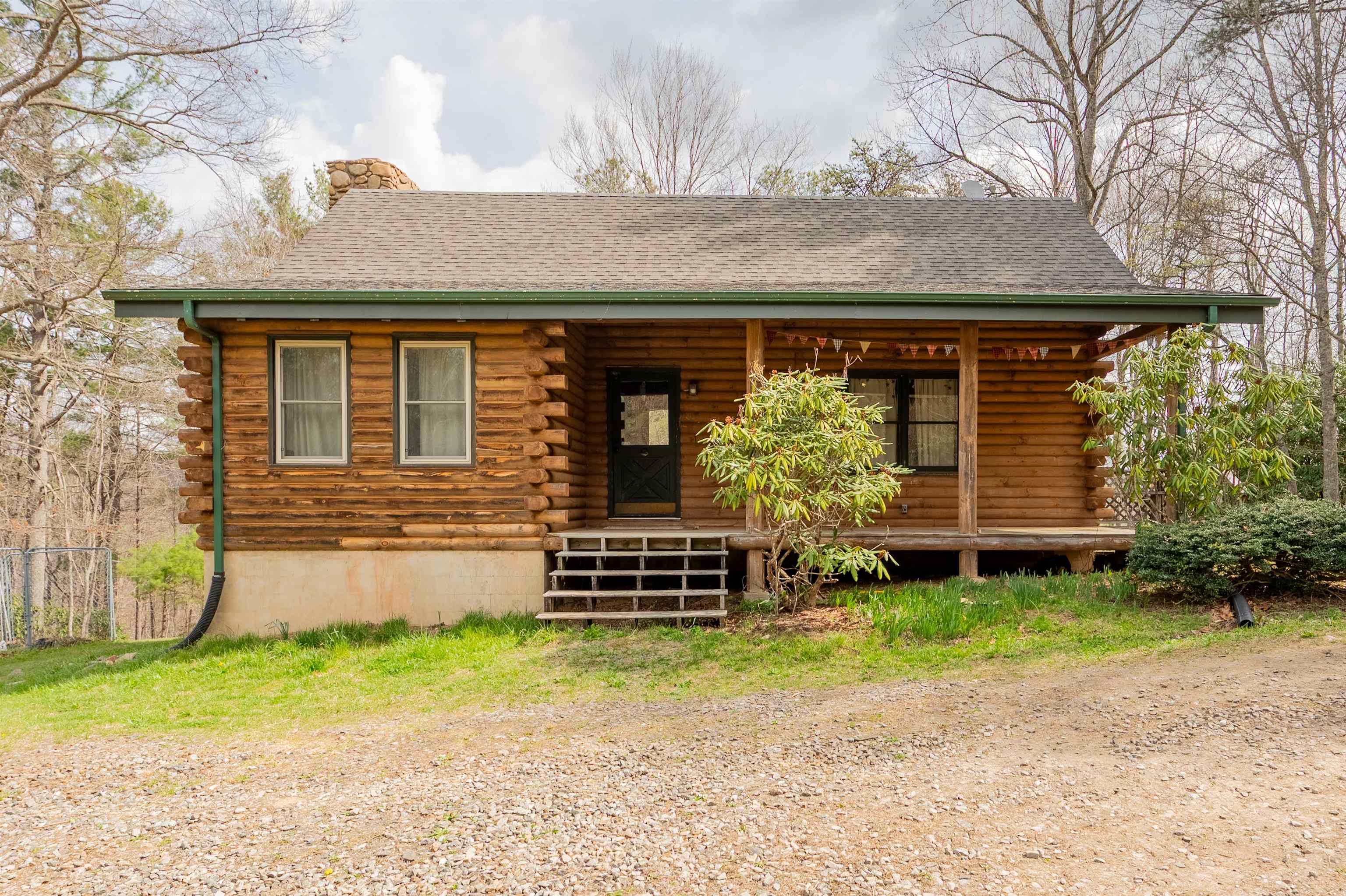 Escape to ultimate seclusion with this log cabin on 10+ acres in the Blue Ridge Mountains, just 10 minutes from the Town of Floyd, Virginia. Featuring over 440 feet of Little River frontage, the property showcases dramatic rock cliffs and a well-maintained trail leading to the water. The main level offers a bedroom, full bath, kitchen, and cozy living room w/ wood burning fireplace. Enjoy nature year-round from the large covered and screened-in back deck. A partially finished basement provides additional space with room to expand. A graded area offers excellent potential for another home, garage, or outbuilding. A rare blend of privacy, natural beauty, and convenience!