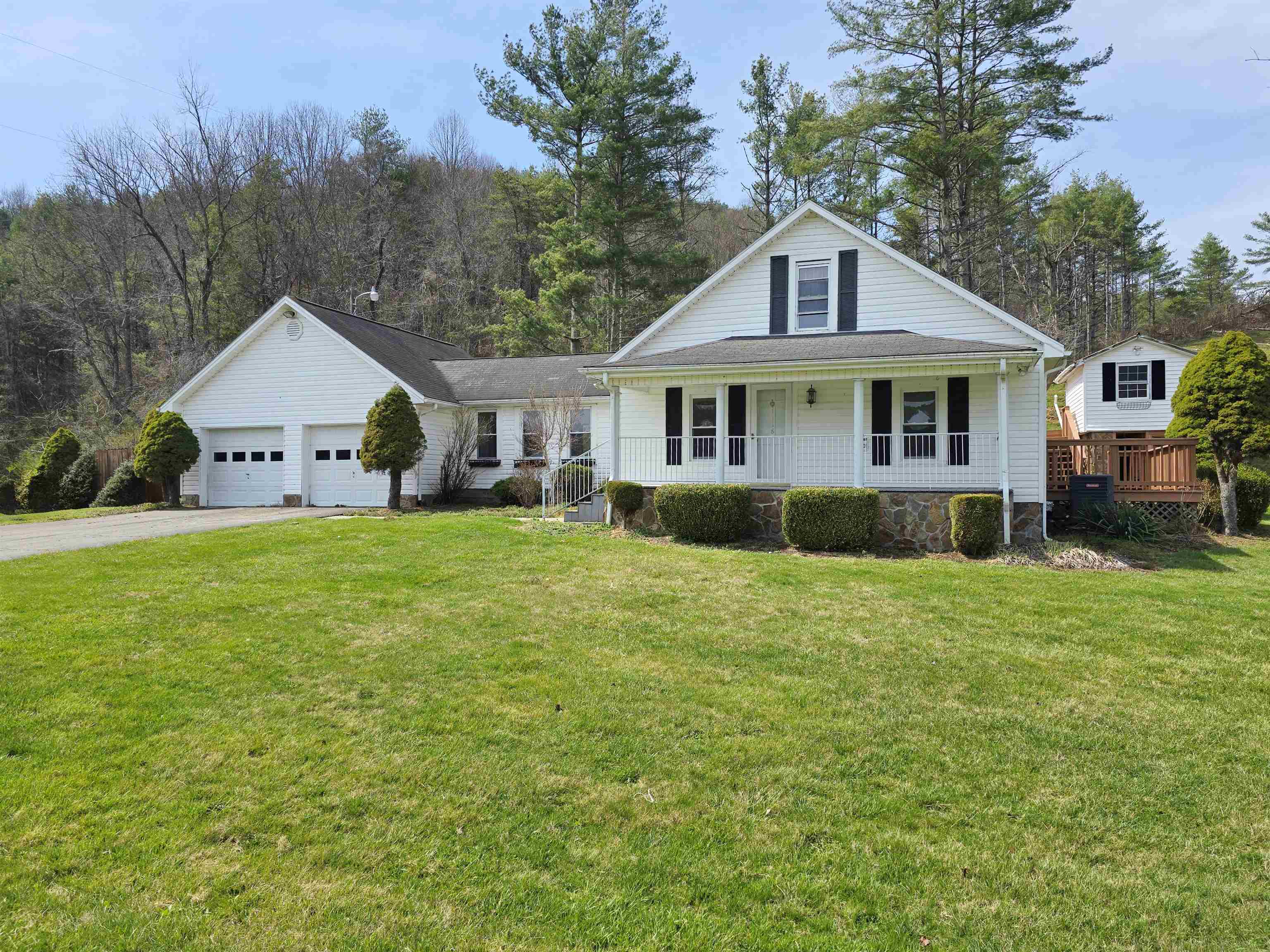 Auction Property: List price may not reflect final sales price. List price is current bid on the property and is non-reflective of value. This charming cottage-style home presents inviting living areas with authentic period charm. The residence combines cozy comfort with distinctive architectural features and thoughtful interior layouts. This three-bedroom, two-bathroom home features stunning Blue Ridge Mountain views and rolling pasture vistas. The kitchen includes granite countertops, while mountain view windows frame the scenic surroundings. The secluded backyard retreat offers an ideal escape, complemented by an outdoor entertaining area perfect for gatherings. A covered front porch provides additional space to appreciate the peaceful setting and beautiful views. The property includes pasture suitable for livestock with a natural spring, making it perfect for agricultural pursuits. Located near New River Trail State Park.