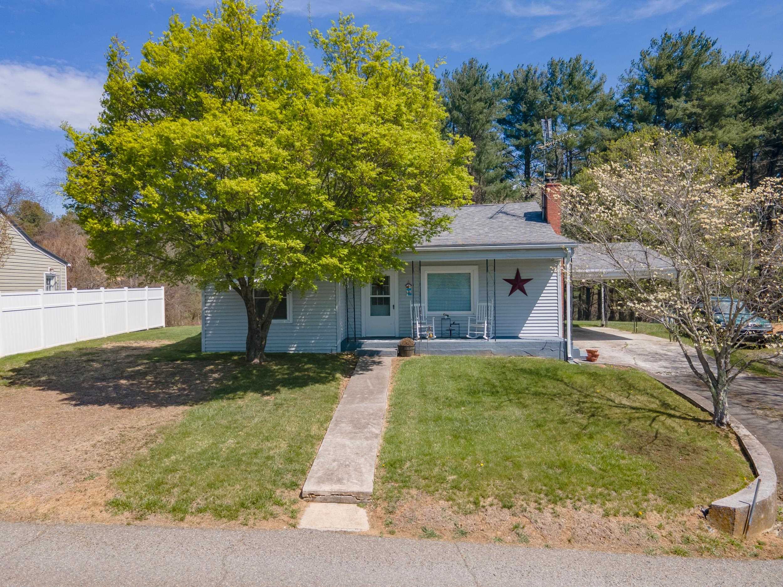 Charming cottage in the heart of Hillsville! Welcome to 210 Sutherland St—perfectly located just off Main Street, offering peace and privacy while still within easy walking distance to the farmers market, local shops, and dining.  This move-in ready home features newer flooring and a forced air oil furnace for efficient heating. The flat yard is ideal for relaxing or entertaining, with beautiful flowering trees and a cozy swing set adding to its charm. Enjoy outdoor living from the covered porch, and take advantage of the oversized carport for convenient parking.  Connected to town water and sewer, this home offers both comfort and reliability. Whether you’re a first-time buyer or looking to downsize, this property is a perfect fit.  Conveniently located within two hours of Roanoke, Winston-Salem, Greensboro, and Bristol.  Don’t miss this opportunity—call today to schedule your showing! Home being sold as-is
