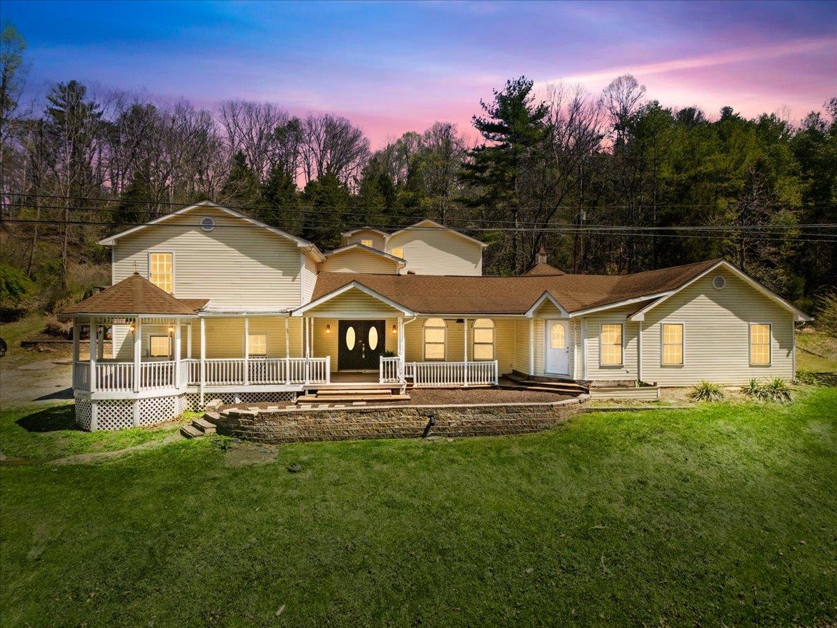 Expansive retreat near Claytor Lake offering exceptional space, flexibility, and income potential. With 6 bedrooms and 3.5 baths, this impressive residence is ideal as a luxury getaway, full-time home, or outstanding bed-and-breakfast or Airbnb opportunity. Thoughtfully updated interior provides a refined, comfortable feel throughout. The main level features a spacious kitchen and multiple gathering areas, along with laundry on both the first and second floors for ultimate convenience. All bedrooms are generously sized, with most opening to private wood decks/balconies for seamless indoor-outdoor living. The primary suite is a true retreat with a fireplace, private parlor sitting area, custom oversized walk-in closet, and spa-inspired bath experience. A welcoming front gazebo and abundant outdoor spaces enhance the retreat feel. Minutes to DeHaven Park, Claytor Lake access, Radford University, and I-81. A rare opportunity of scale and possibility. Call for your private tour today!