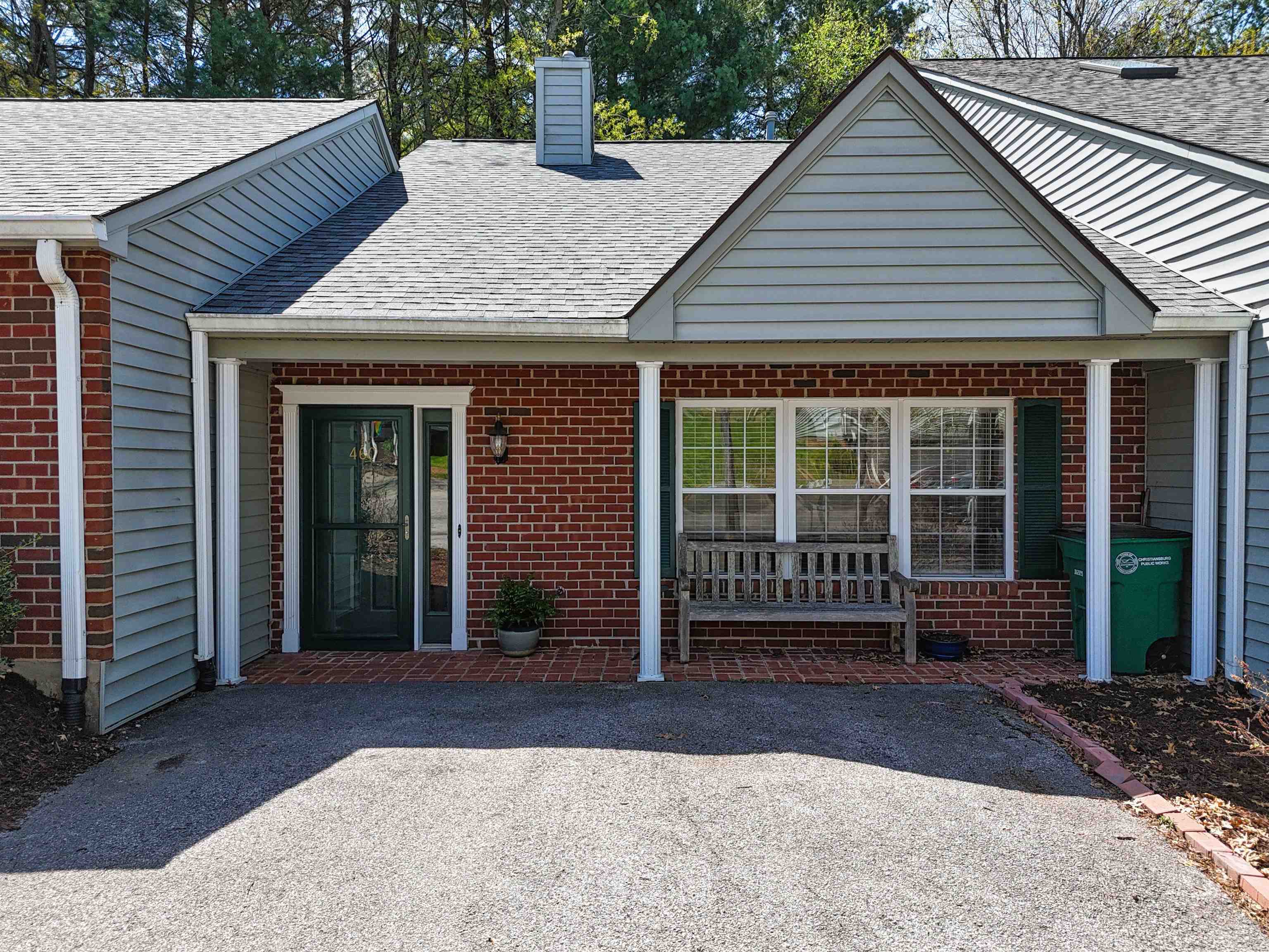 A charming 1 level townhome with a welcoming, covered front porch. Laminate wood flooring throughout, new refrigerator & microwave in 2025, new garbage disposal in 2024.  A gas log fireplace in the open dining/living room area.  A shady patio in back for grilling out or enjoying morning coffee.