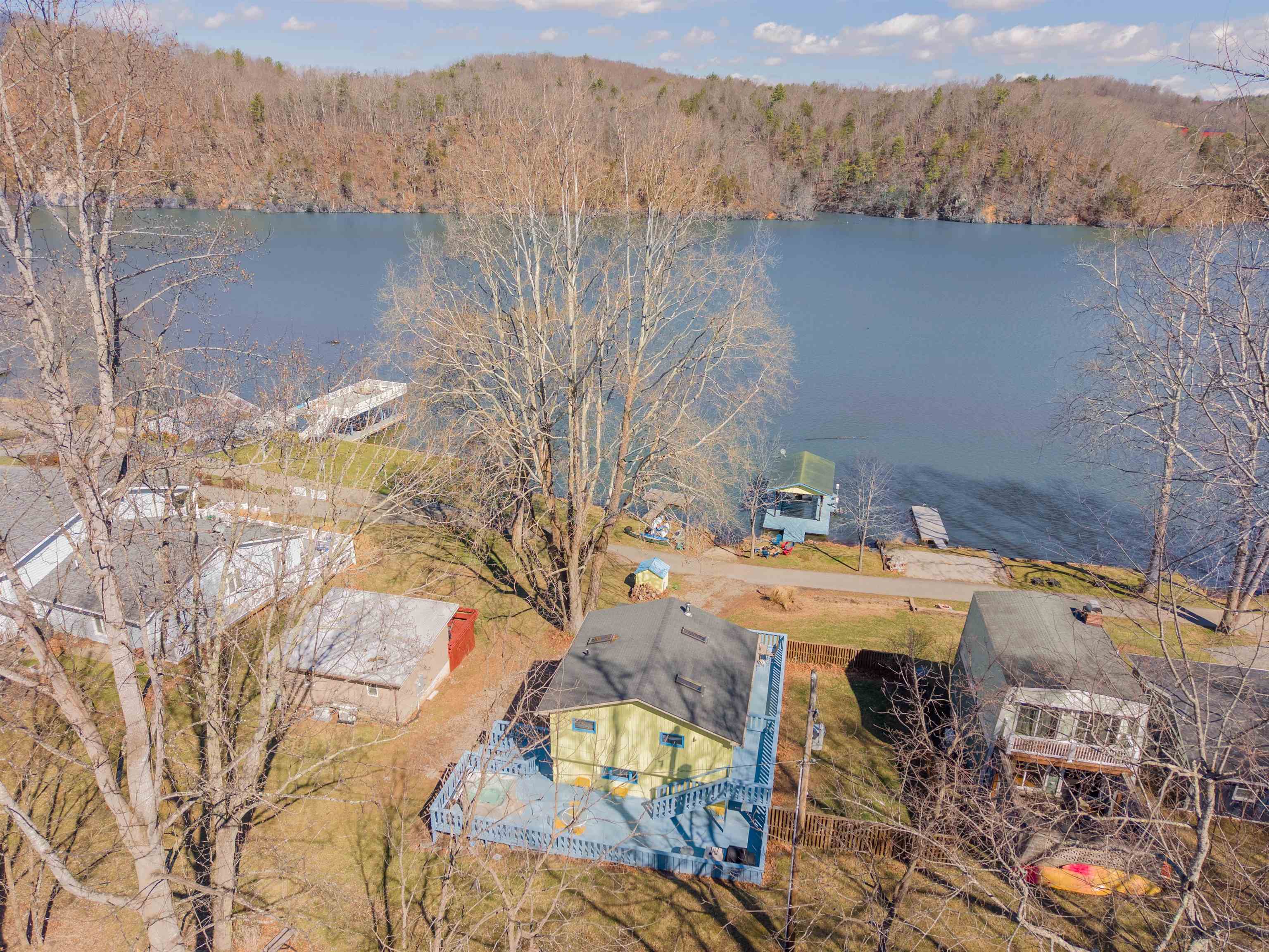 Welcome to 2939 Blackberry Lane, a stunning one bedroom bungalow with high end finishings, a spacious deck overlooking the lake, and a private dock. Inside you'll find a well appointed open kitchen and living room, a full bath, laundry room, and a sun-dappled bedroom with lake views! With shiplap walls, custom kitchen cabinets, and heated flooring, this is a truly unique find on the lake! Be ready to enjoy summer right away - this home comes furnished & ready to go! As an active short-term rental, this property is not only enjoyable for you, but is also an income-producing investment!