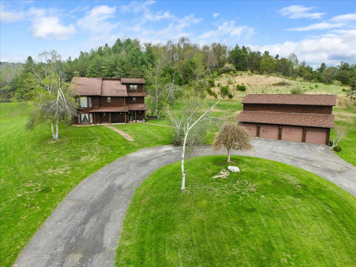 Breathtaking property with views, private setting and room to enjoy the outdoors.  5,000 square feet home on 3 levels contains 5 bedrooms and 4 bathrooms.  The brick floors on the main level are very warm and inviting. Multiple fireplaces give character and there is room to spread out throughout the home.  The detached 4 car garage also has a game room above for additional room to relax in.