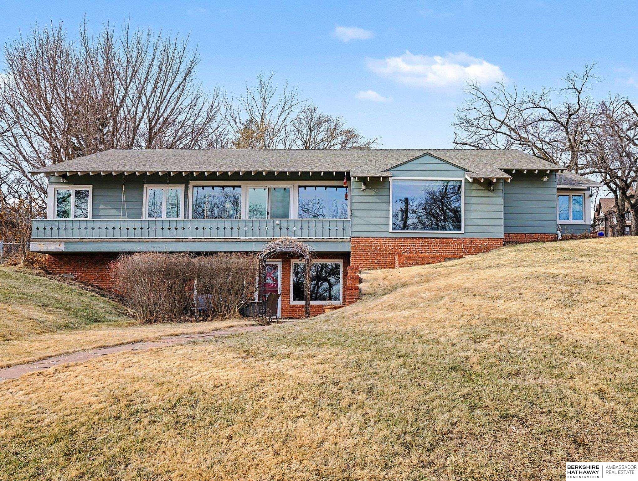 A rare, high-character mid-century ranch with river views, designed by architect John Hyde Jr. (1955). This one-of-a-kind home offers 5 bedrooms and an open, flowing layout filled with natural light, vaulted ceilings, and timeless original details. Enjoy polished concrete floors, multiple fireplaces, and beautifully preserved vintage charm throughout. The finished walkout basement includes a second kitchen and separate entrance that's ideal for guests, multi-generational living, or entertaining. Situated on a scenic lot just over ¼ acre with a balcony, fenced yard, and patio with outdoor fireplace. Attached 2-car garage. A truly special Wyman Heights opportunity that is architectural, spacious, and unforgettable.