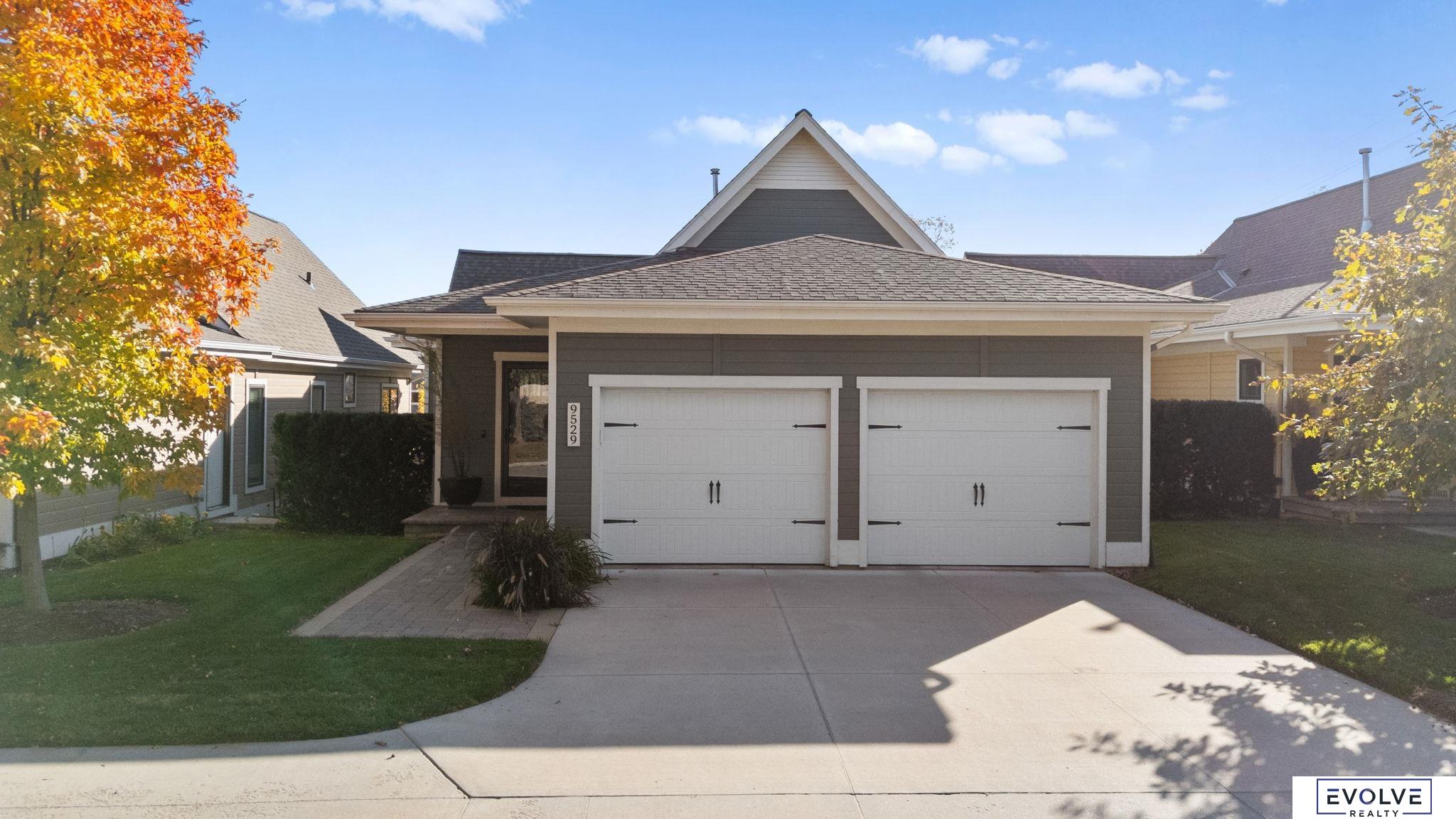 Thoughtfully designed 3 bedroom, 3 bathroom, 2 car ranch home offers comfort, function, and timeless style in one of Omaha’s most vibrant and established neighborhoods. The open main level features a natural flow between the kitchen, dining, and living areas, ideal for both everyday living and entertaining. The primary suite is conveniently located on the main floor with a well-appointed bathroom and generous closet space, while a second bedroom and full bath provide flexibility for guests or a home office. The walkout basement adds valuable living space with a spacious family room, third bedroom, and full bathroom, all filled with natural light and ideal for hosting or creating a private retreat.  Located within the Cottages of Oakdale, this standalone custom home includes its own private yard and a welcoming front porch facing a shared green space. The neighborhood is conveniently close to retail shops, grocery stores, pharmacies, golf courses, trails, and parks.