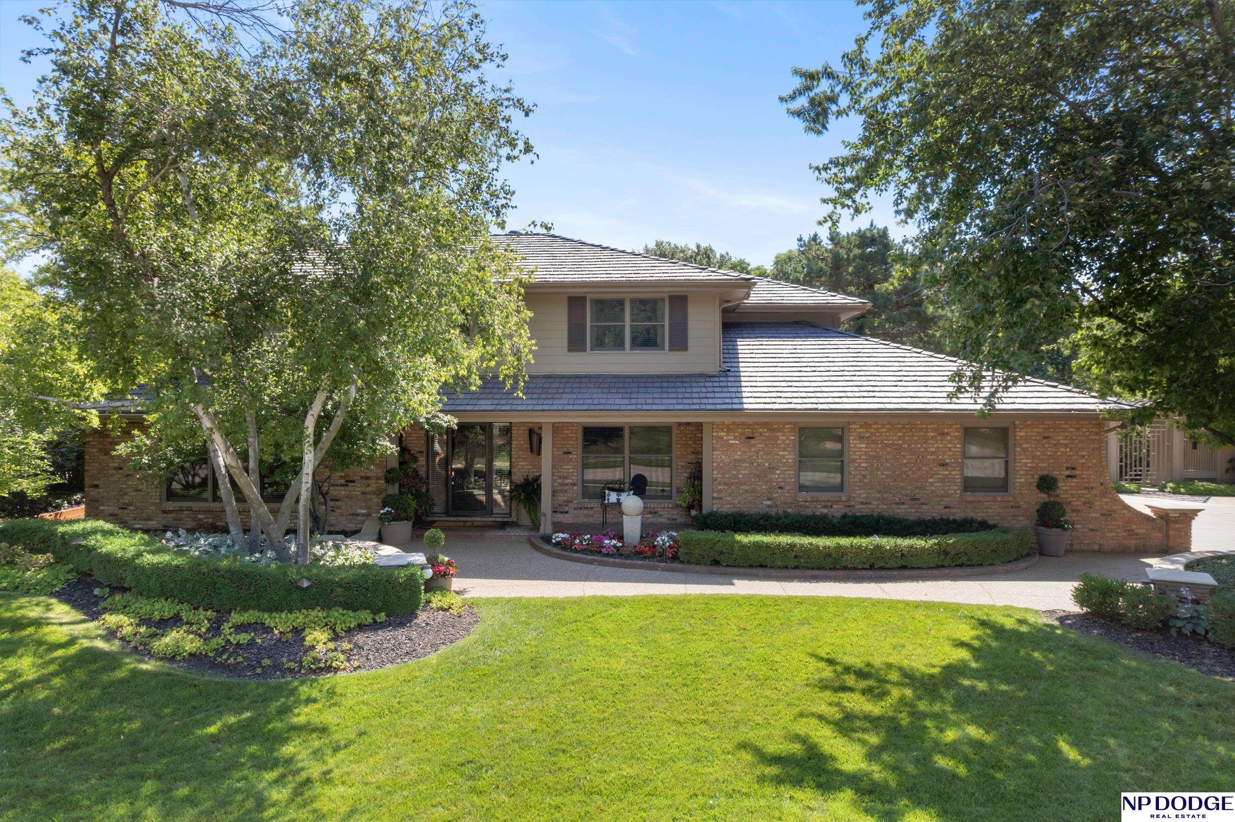 This stately brick 2 story is tucked into Omaha's coveted Regency neighborhood within the prestigious District 66 school district, celebrated for its family-friendly atmosphere, spacious lots, top-rated schools, walking paths, and central park amenities. Set on a generous lot at the end of a quiet cul-de-sac, the home offers exceptional privacy and tranquility. The upper level features 5 spacious bedrooms and 4 bathrooms, ideal for family living or hosting guests. Thoughtfully expanded by renowned builder John Offutt, the home showcases seamless craftsmanship and meticulous upkeep. Additional highlights include a main-floor office and laundry, a durable composite roof, and an oversized deck perfect for entertaining. A rare, move-in-ready opportunity in one of Omaha's most desirable communities. AMA