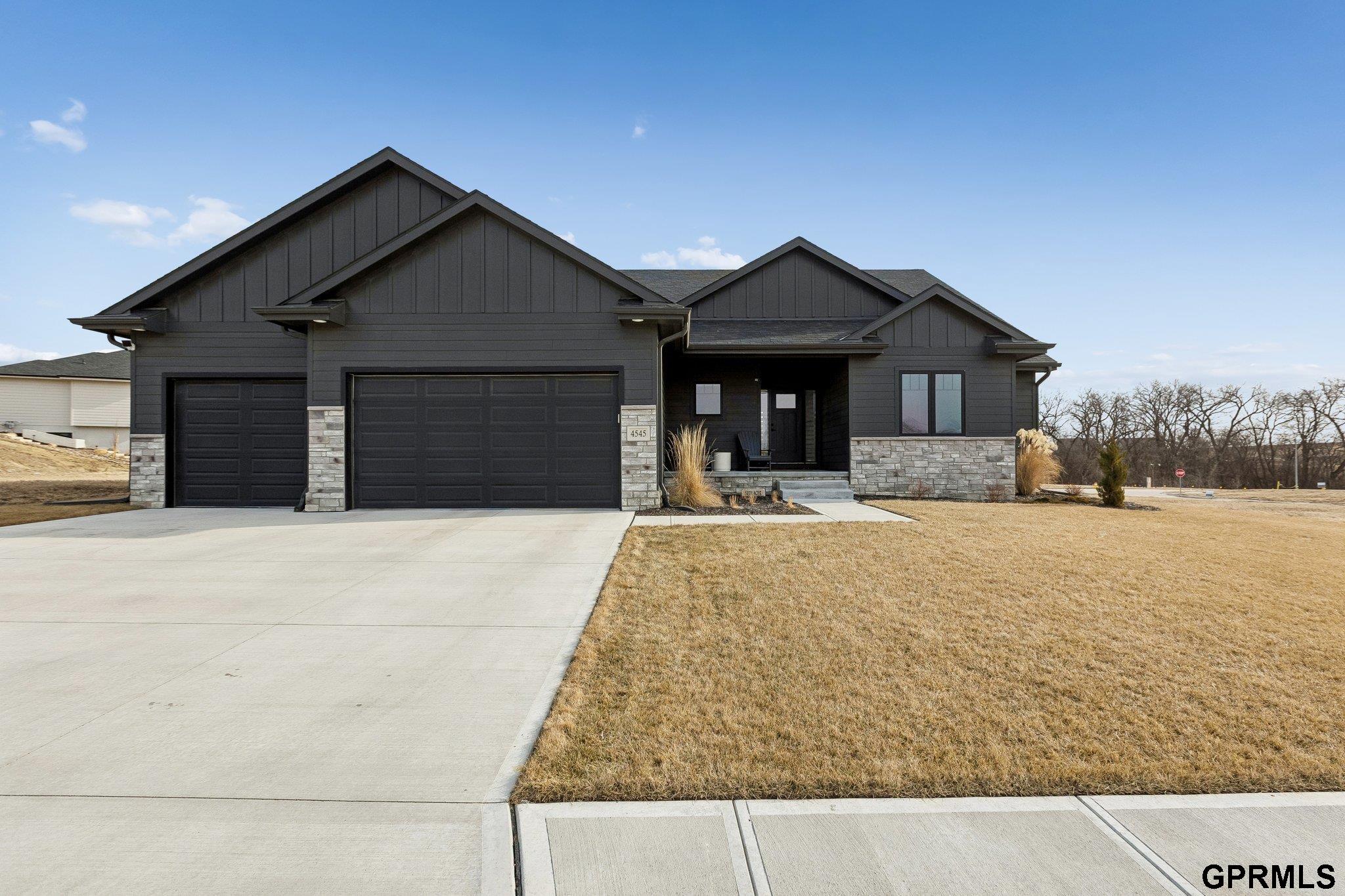 Welcome to this meticulous, better-than-new home loaded with upgrades throughout. Flawless, open layout plan with soaring 10–11' ceilings and superior craftsmanship throughout. You'll love the large windows that line the back of the home, flooding it w/ natural light. The stunning kitchen features a large island, gas range, custom cabinetry & countertops, and an oversized hidden walk-in pantry. The main floor offers a desirable split-bedroom design w/ 2 bedrooms on one side and a private primary retreat on the other.  The huge lower level includes a spacious family room, 2 additional bedrooms, and a dedicated workout room. Truly move-in ready, this home showcases custom window shades, James Hardie siding, 2x6 exterior walls, high-efficiency HVAC and more. Enjoy the large, flat backyard w/ a 6' fence—perfect for relaxing or entertaining. This gorgeous home is packed with thoughtful details & upgrades you have to see to appreciate. It shows like a model home! Schedule your showing today.