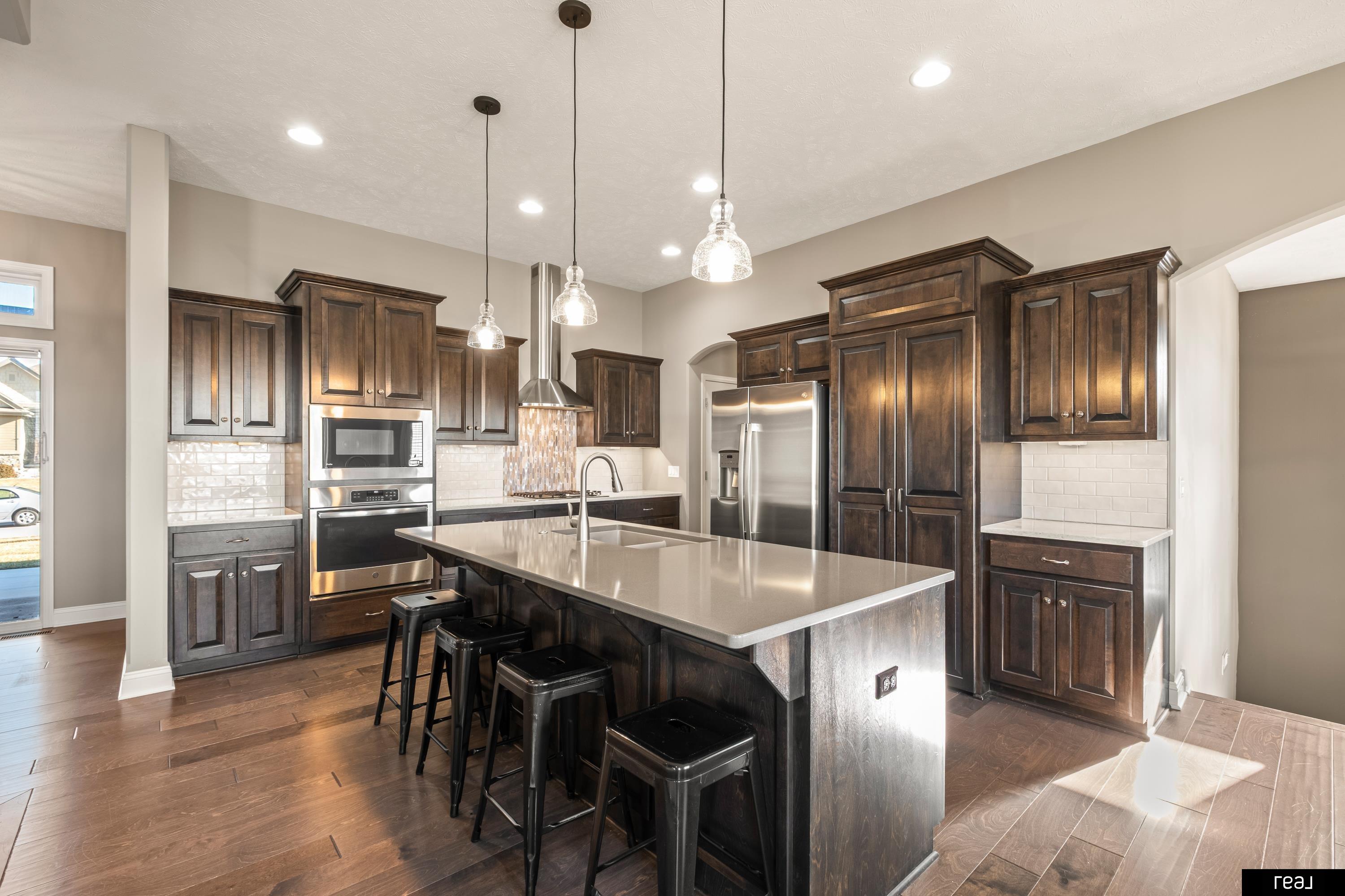 OPEN HOUSE THIS SUNDAY 2/15 FROM 1-3PM!!!  This one-owner 5-bedroom, 3-bath ranch showcases quality construction and pride of ownership throughout. The open-concept layout flows into a well-appointed kitchen with Quartz countertops, stainless steel appliances, and a spacious walk-in pantry—ideal for both everyday living and entertaining. The main level features a generous primary suite with a private bath and walk-in closet, along with two additional bedrooms and a full bath.  The walkout lower level includes a large family room with wet bar, two more bedrooms, and a ¾ bath—perfect for guests or extended living. Outside, enjoy a fully fenced backyard with a covered deck, lower patio, and sprinkler system. A rare heated 4-car garage sets this home apart, complete with epoxy floors, wall racking, and built-in storage cabinets that stay. Just minutes from the popular new Gretna Hy-Vee, dining, fitness centers, bars, and the new YMCA, this home delivers upscale comfort in a prime location.