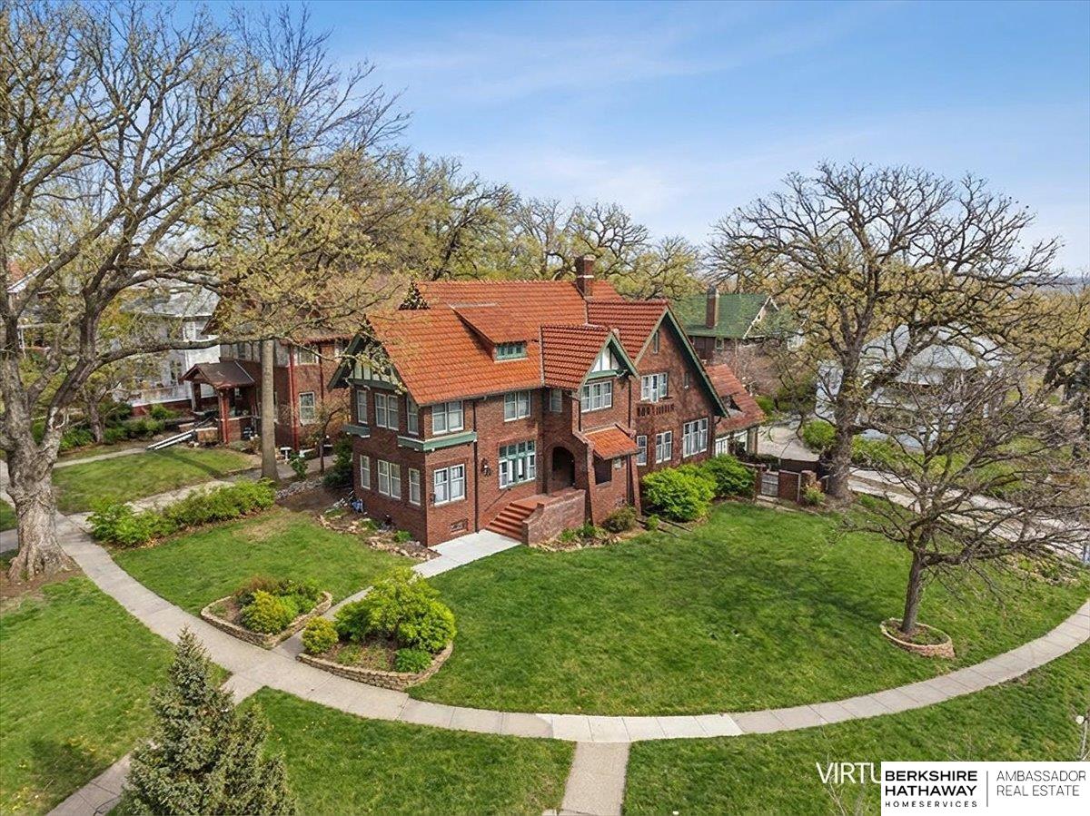 A rare offering blending historic prestige with refined French Country luxury, this extraordinary residence showcases timeless craftsmanship and architectural artistry. Its striking masonry exterior, steep rooflines, and elegant arched entries evoke classic European charm. Inside, rich woodwork, custom beveled-glass French doors, and artisan finishes create warmth and sophistication throughout. The living room features a dramatic leather ceiling imported from Paris, adding unforgettable texture and character. A hand-painted mural transforms the dining room into an artistic centerpiece, perfect for entertaining and memorable gatherings. Designed for those who value history, craftsmanship, and elevated living, this legacy property offers expansive spaces balanced by intimate charm where European elegance, character, and luxury meet in a way rarely found and impossible to replicate.