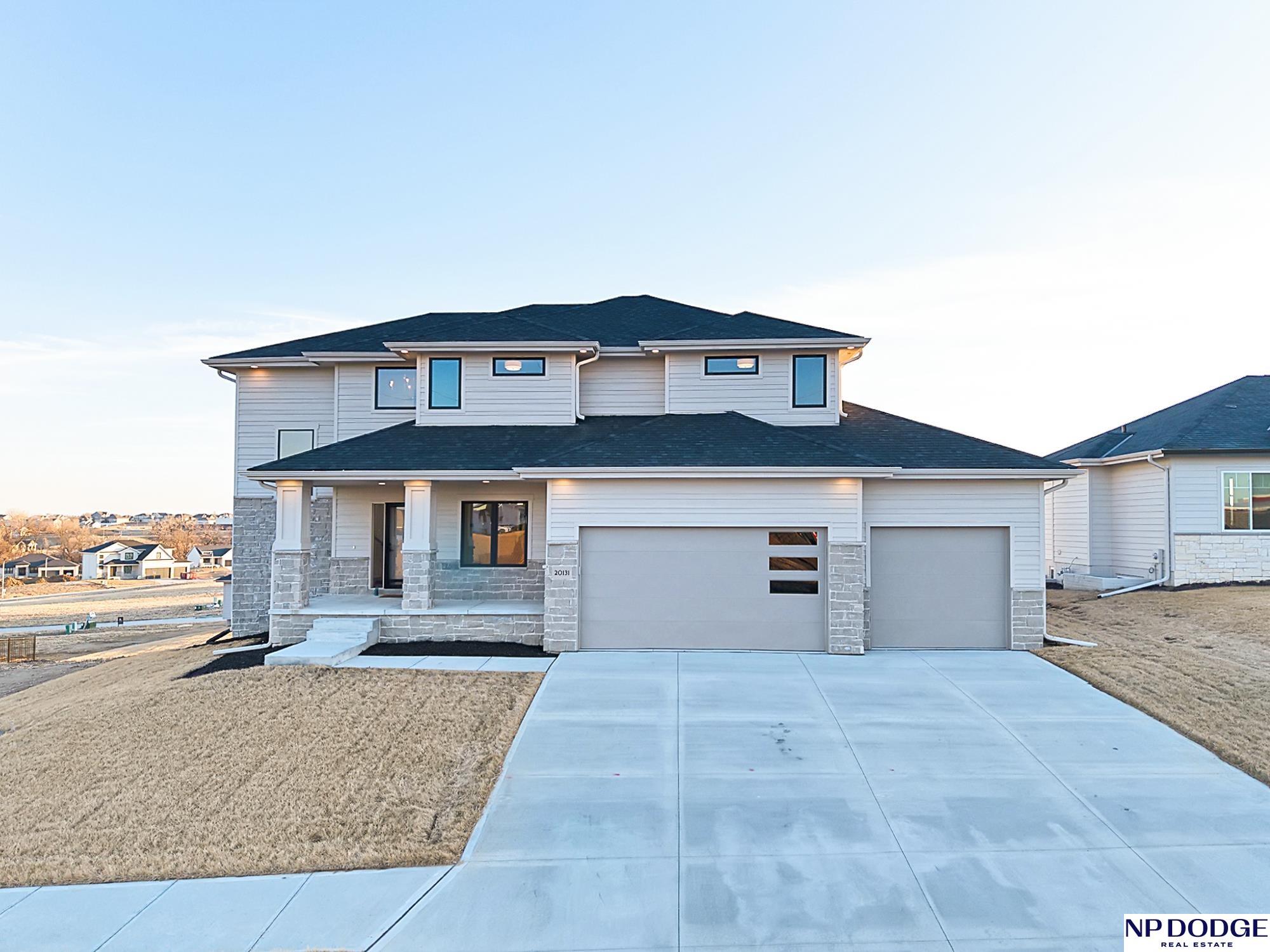 This is the upgrade you’ve been waiting for. From the moment you step into the two-story foyer, the home immediately feels elevated. Built by Rose Creek Homes, it offers open, light-filled living spaces designed to support both daily life and effortless entertaining. The chef-inspired kitchen anchors the main level with a gas range, double ovens, vented hood, and an oversized walk-in pantry—ideal for busy weeks or hosting with ease. Living and dining areas flow seamlessly, creating a layout that’s both functional and inviting. Upstairs, the primary suite offers the privacy you’ve been missing with a soaking tub, dual vanities, and separate walk-in closets. A Jack-and-Jill bath, second-floor laundry, and pocket office add thoughtful functionality. Enjoy the covered composite deck and a 3-car garage with tandem bay for storage or hobbies. Located in the Gretna School District, this home delivers space, design, and craftsmanship aligned with refined move-up living.